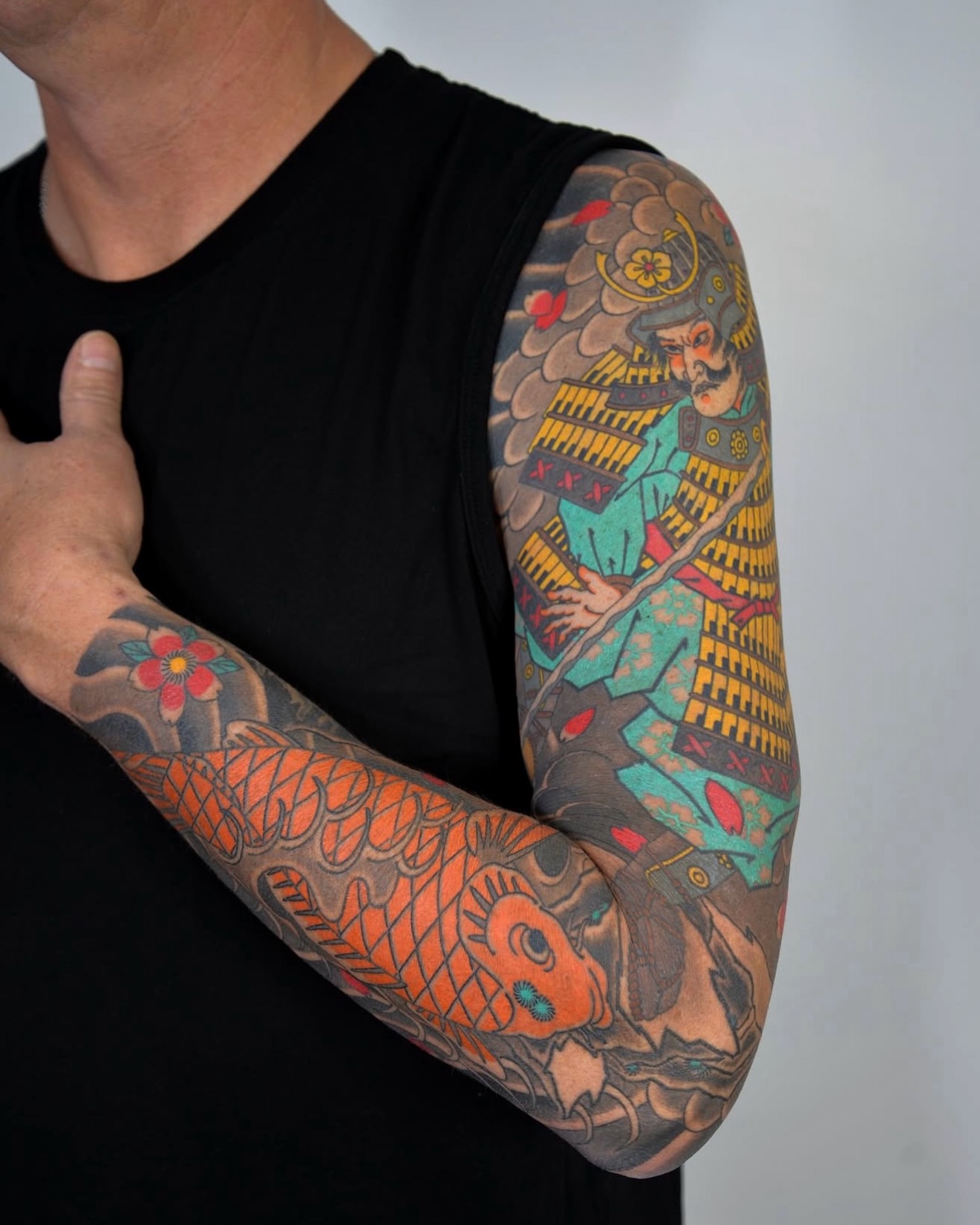 Koi fish and samurai japanese irezumi tattoo on the upper arm by zak brochu, Windsor, Ontario