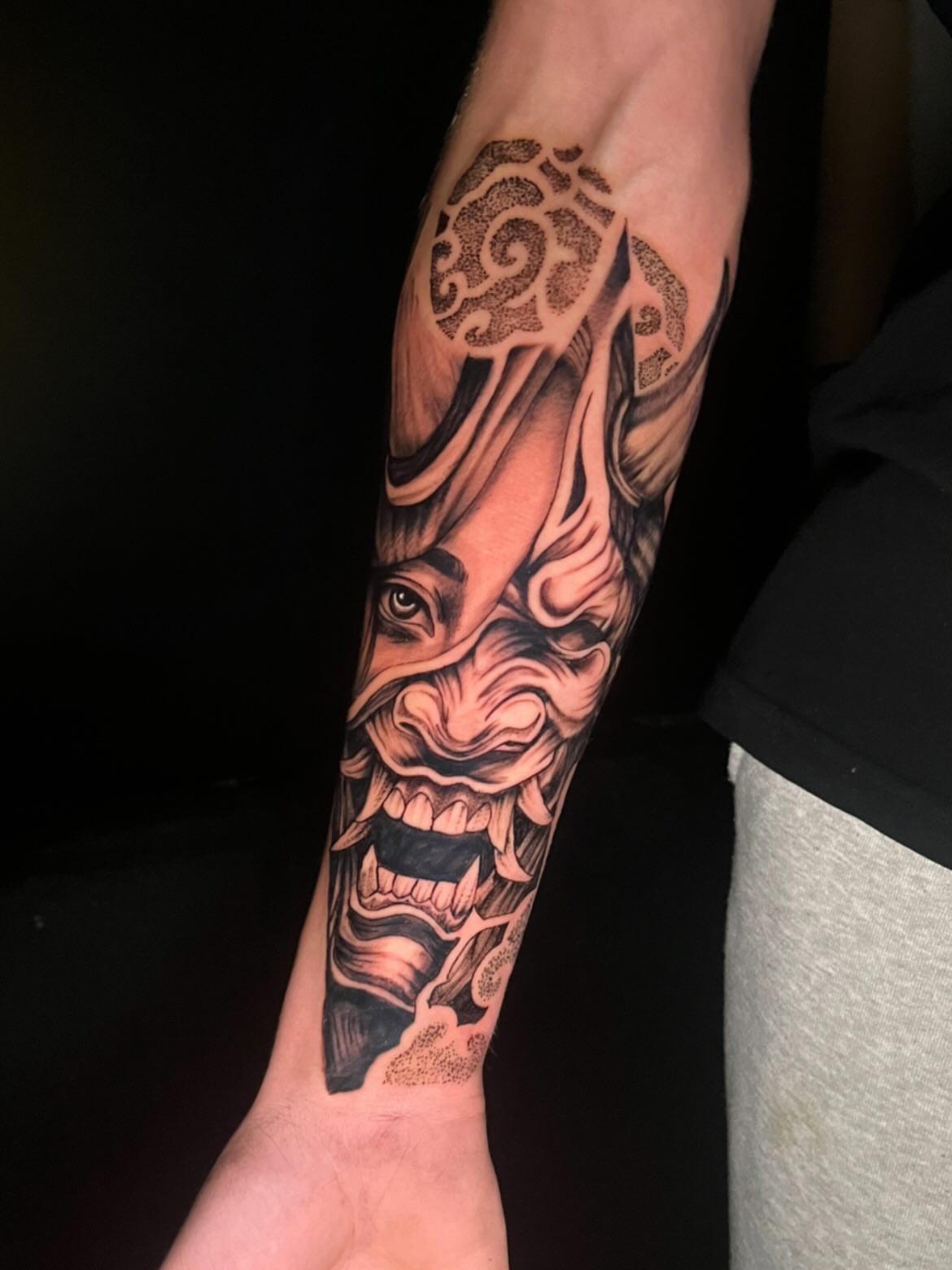 Demon mask realism tattoo on the forearm by Deville Pinson