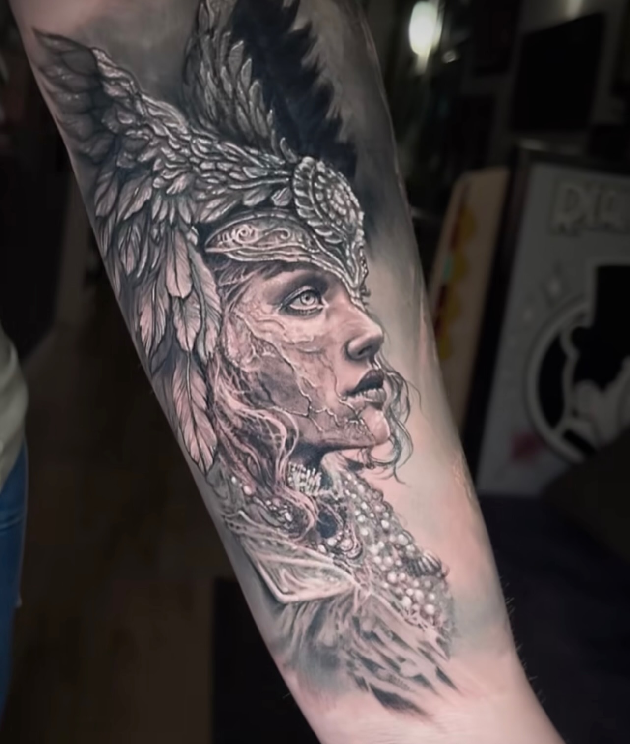Woman with wings realism tattoo on the forearm by Brian Ulibarri