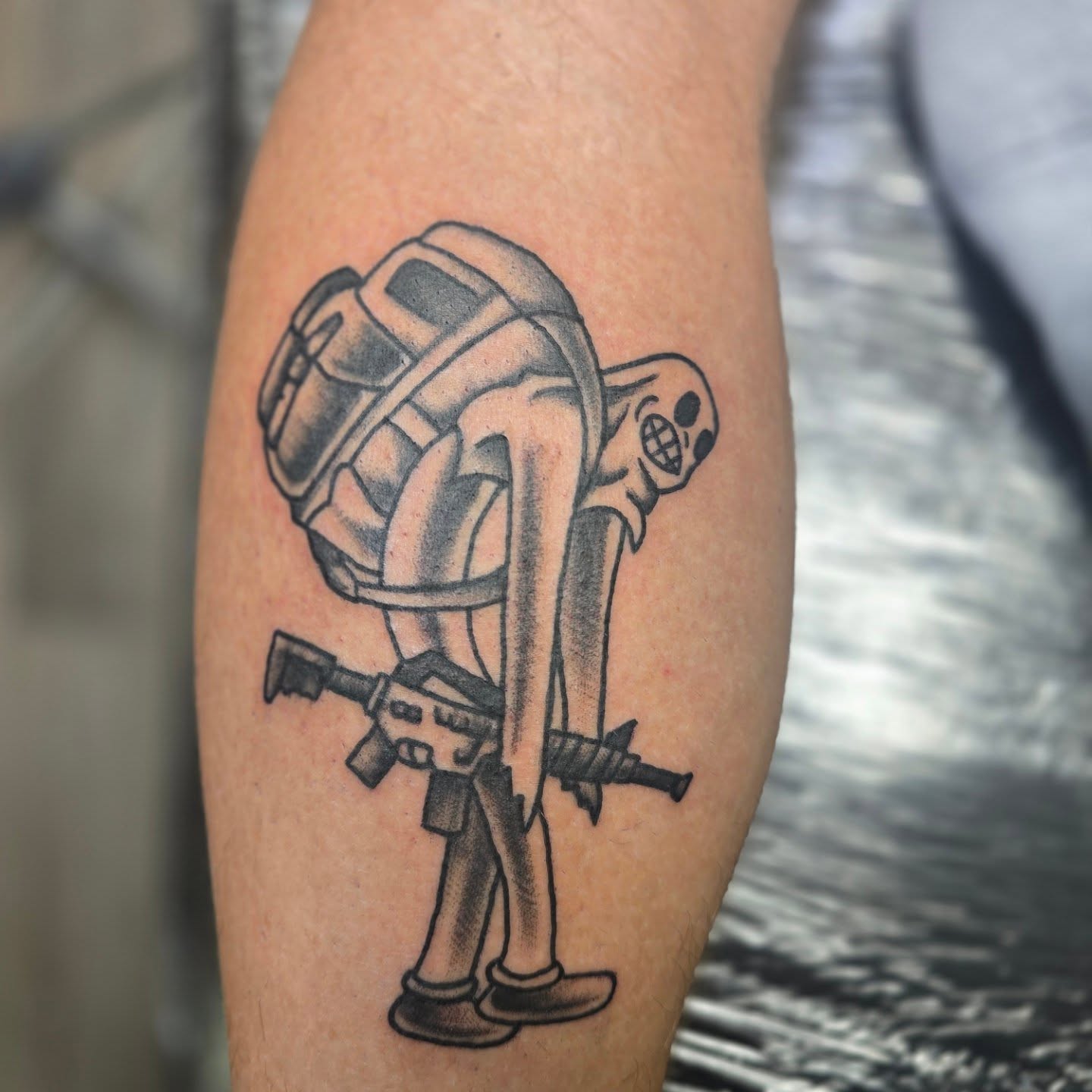 Robotic soldier black and grey tattoo on the forearm by Karen Cain