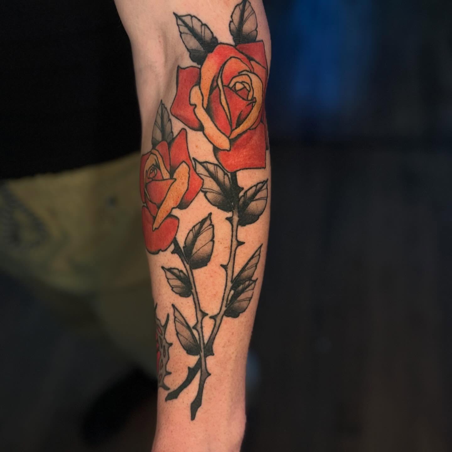 Red roses American traditional tattoo on the forearm by Nathan Thomas