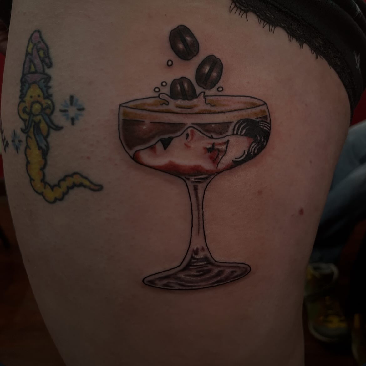 Martini glass with woman American traditional tattoo on the thigh by Chrissy Ungrew Tattoos, Covington, Kentucky