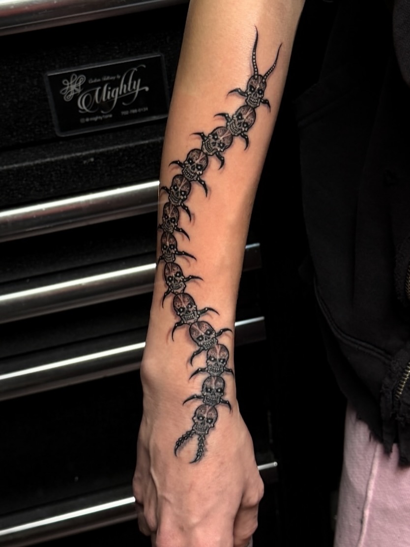 Skulls and scorpions geometric tattoo on the forearm by Gary Chase
