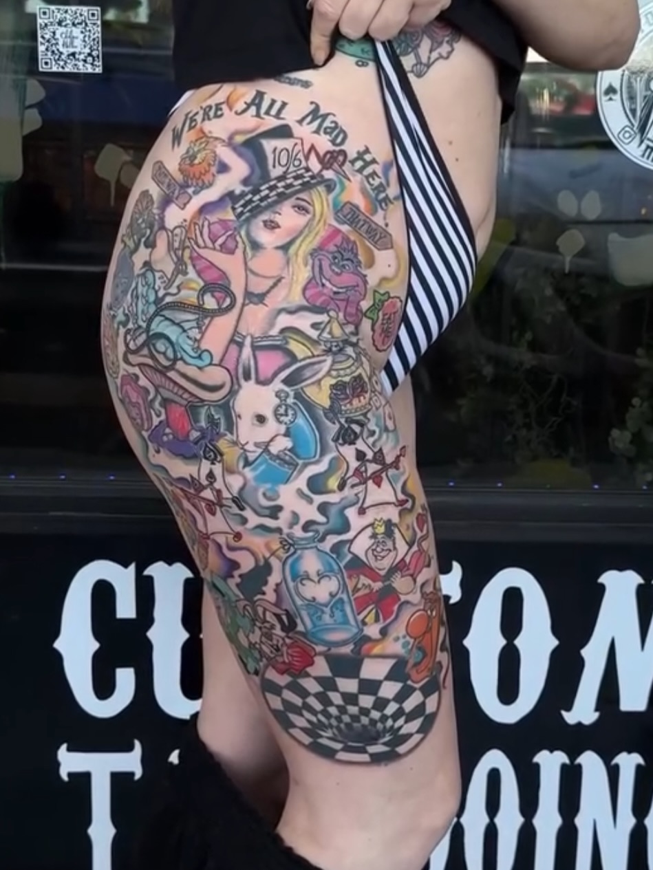 Alice in Wonderland American traditional tattoo on the thigh by Gary Chase