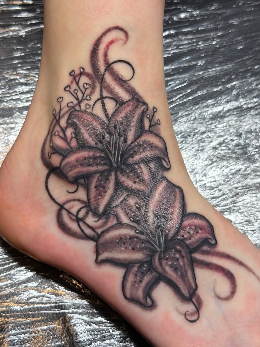 Lilies black and grey tattoo on the foot by Gary Chase
