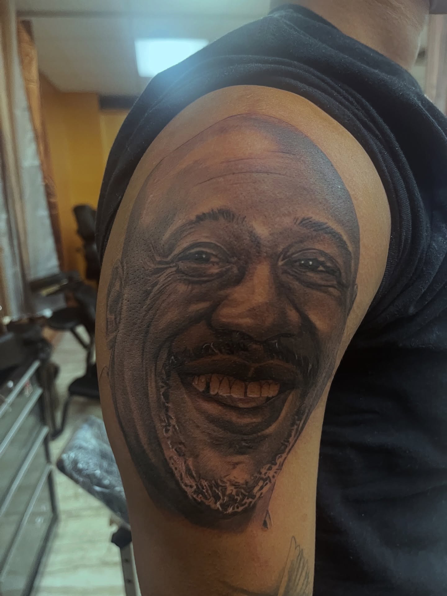 Portrait realism tattoo on the shoulder by Quinten Harper