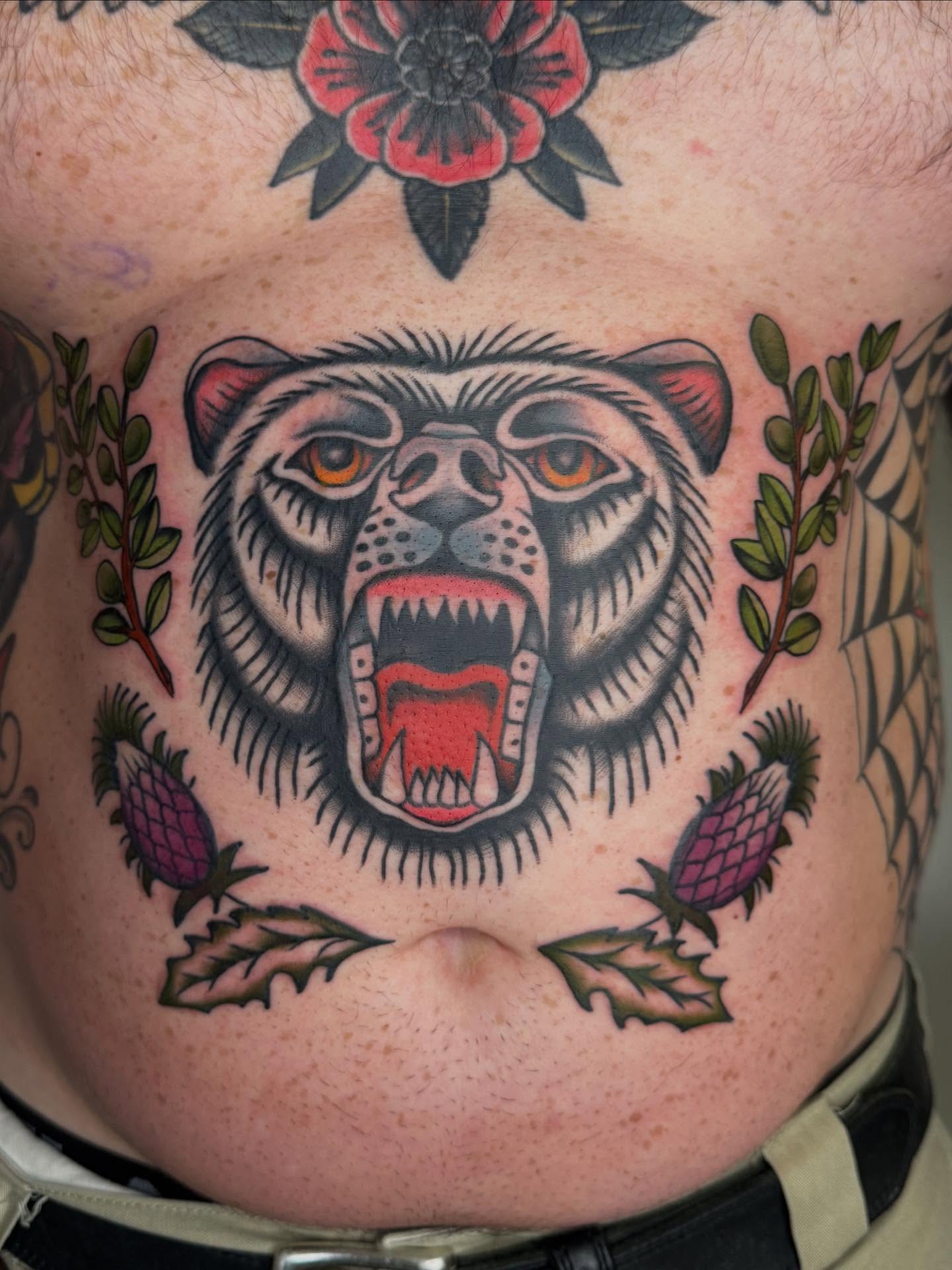 Roaring bear American traditional tattoo on the torso by Jacqui Rose