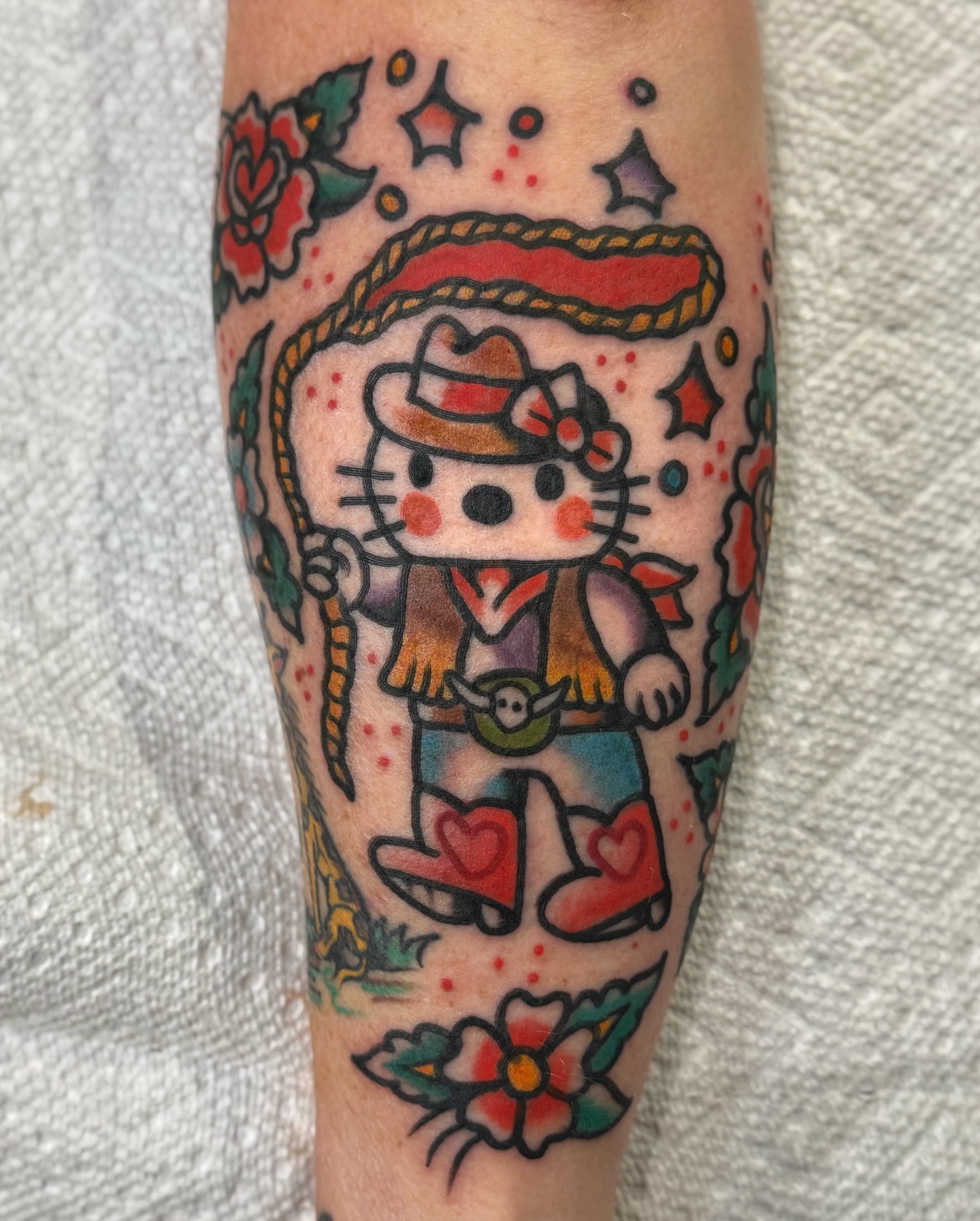 Hello kitty cowboy American traditional tattoo on the forearm by Joe tatum ~Tattoo~