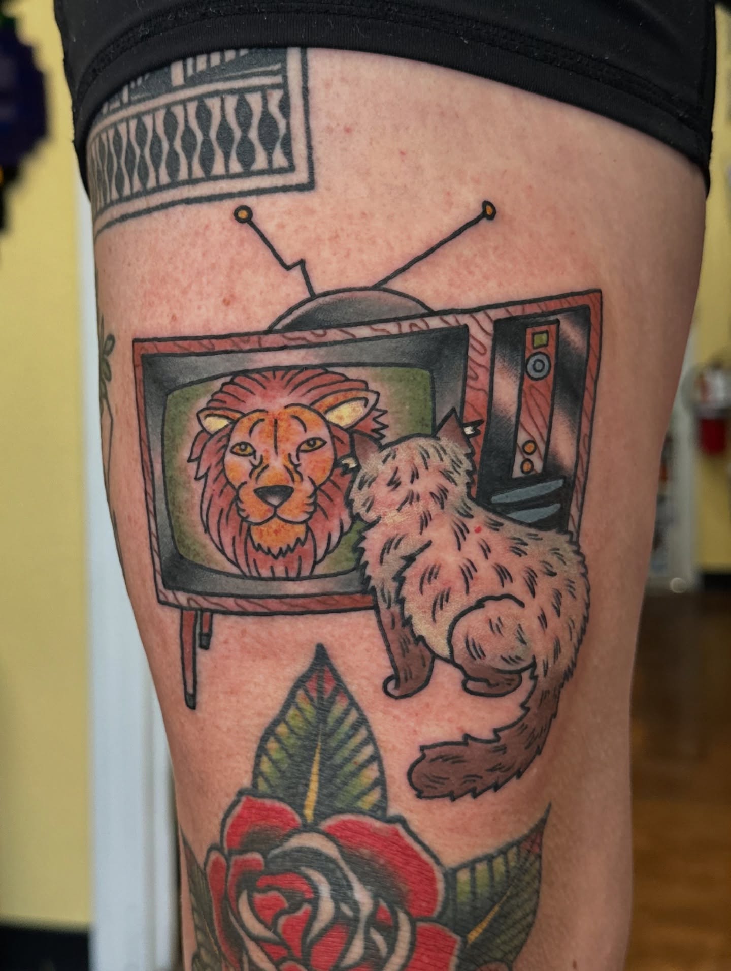 Lion and cat American traditional tattoo on the thigh by Nick Bones, Las Vegas, Nevada