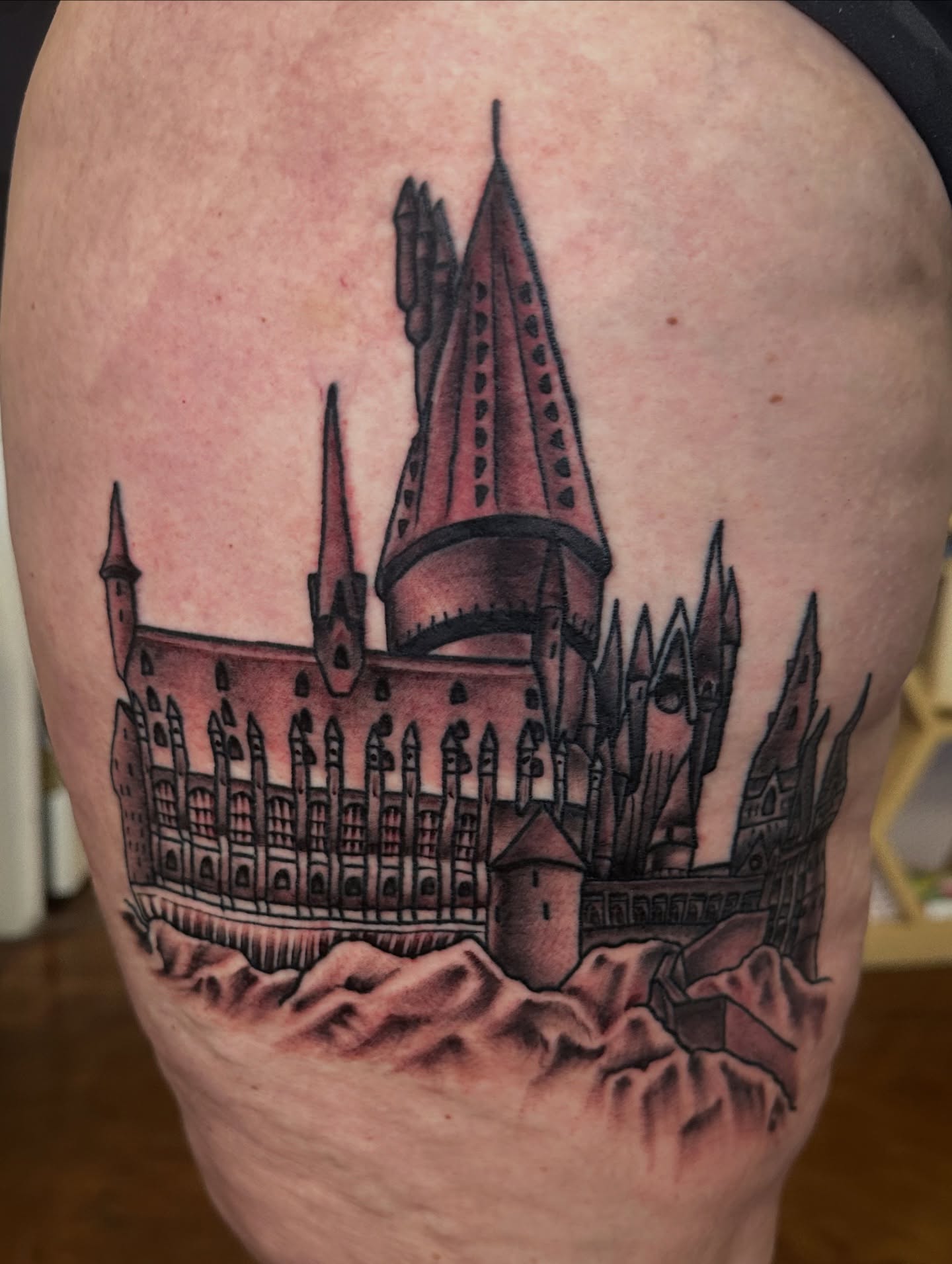 Hogwarts Castle realism tattoo on the thigh by Nick Bones, Las Vegas, Nevada