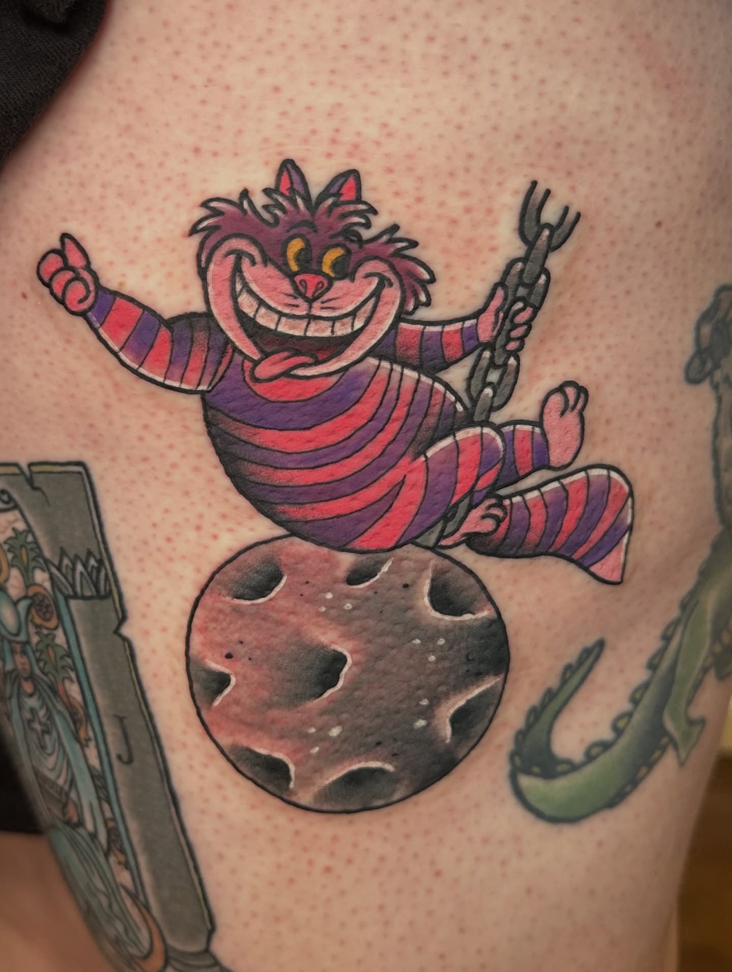 Cheshire cat American traditional tattoo on the thigh by Nick Bones, Las Vegas, Nevada