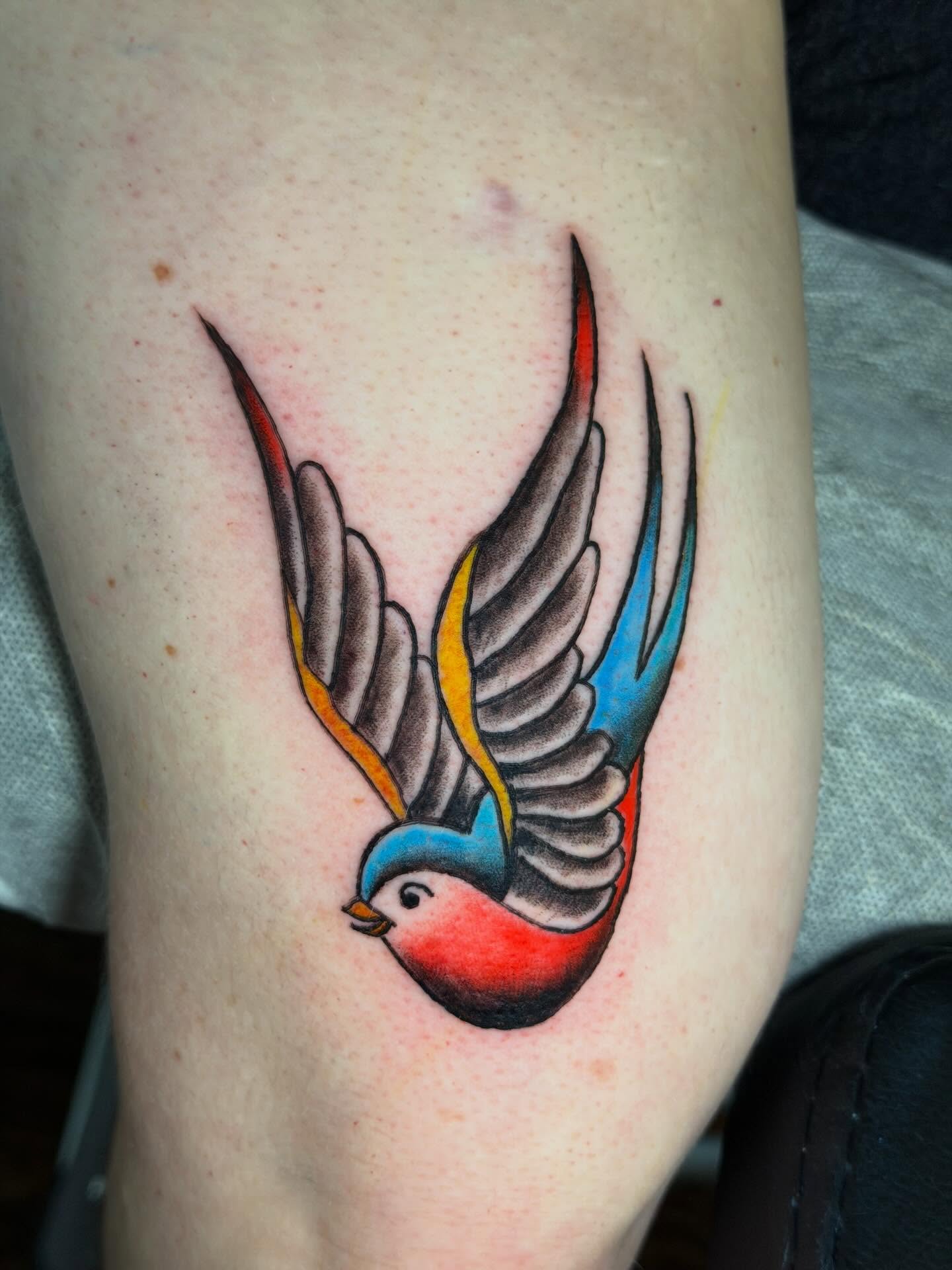 Swallow American traditional tattoo on the thigh by C.J.K. Roy