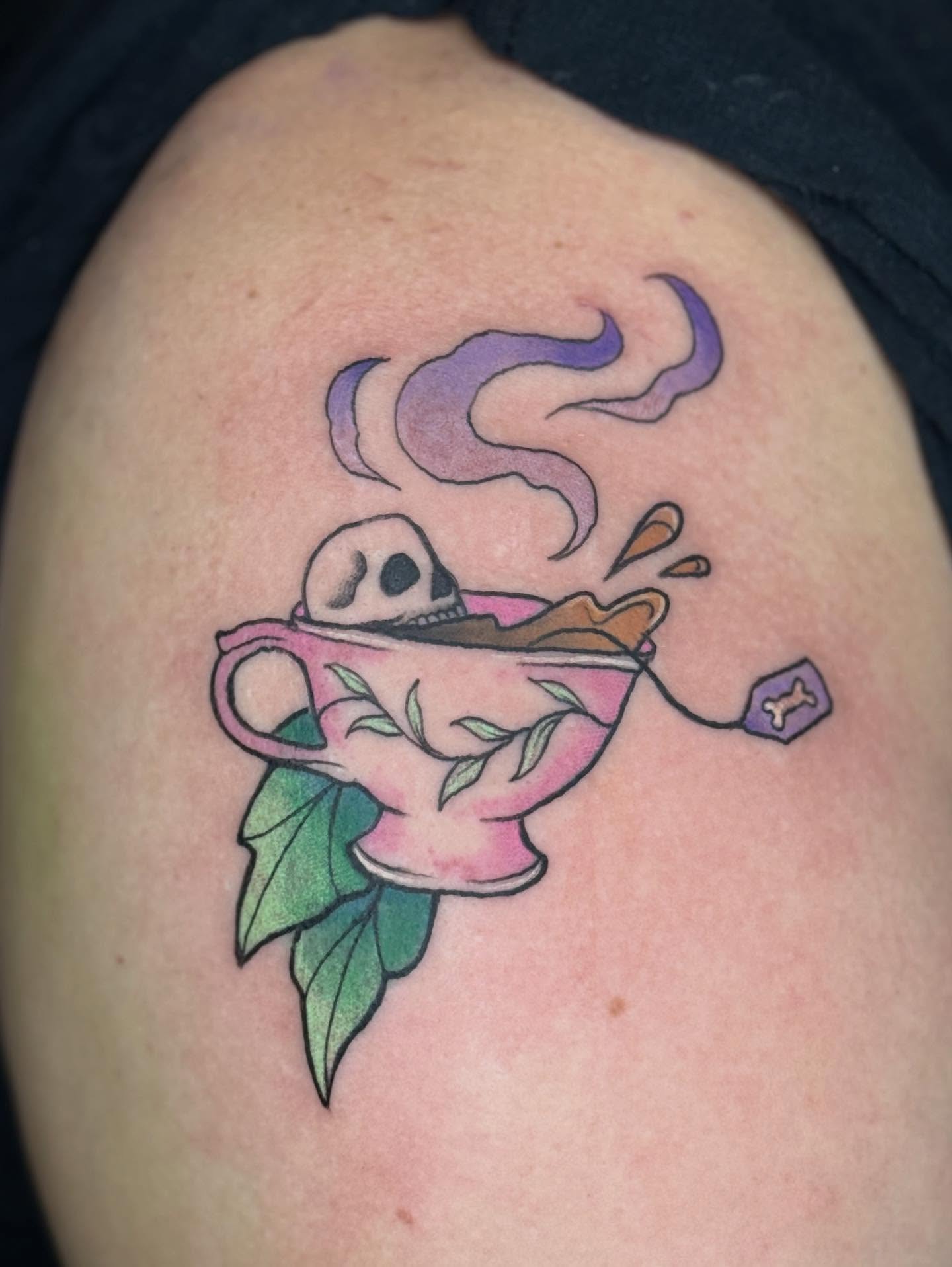 Tea cup with skull new school tattoo on the shoulder by Bry