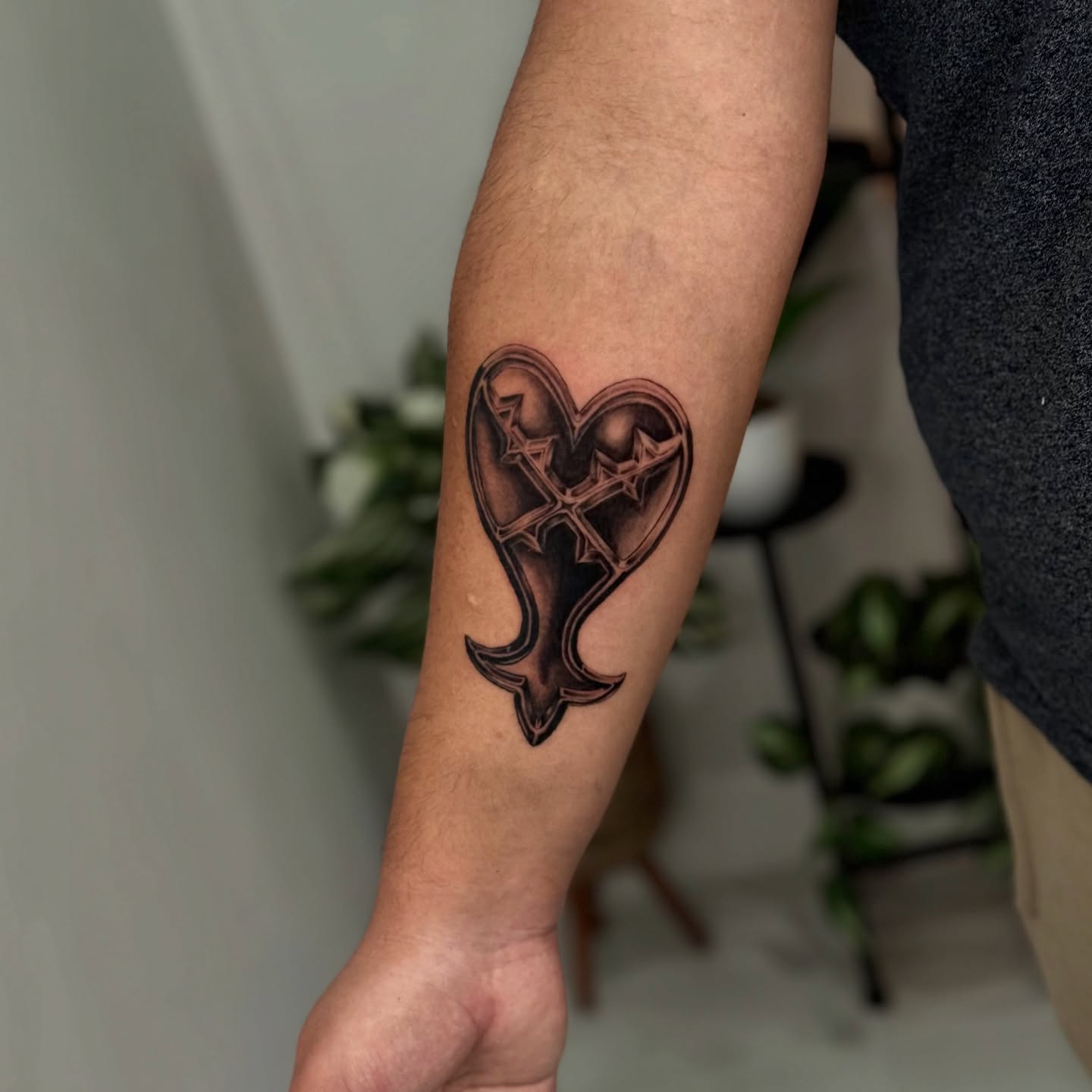Heart with cross black and grey tattoo on the forearm by ♍️𝒾𝒸𝒽𝑒𝓁𝓁𝑒⁺‧₊˚ ཐི⋆♱⋆ཋྀ ˚₊‧⁺, Charlotte, North Carolina