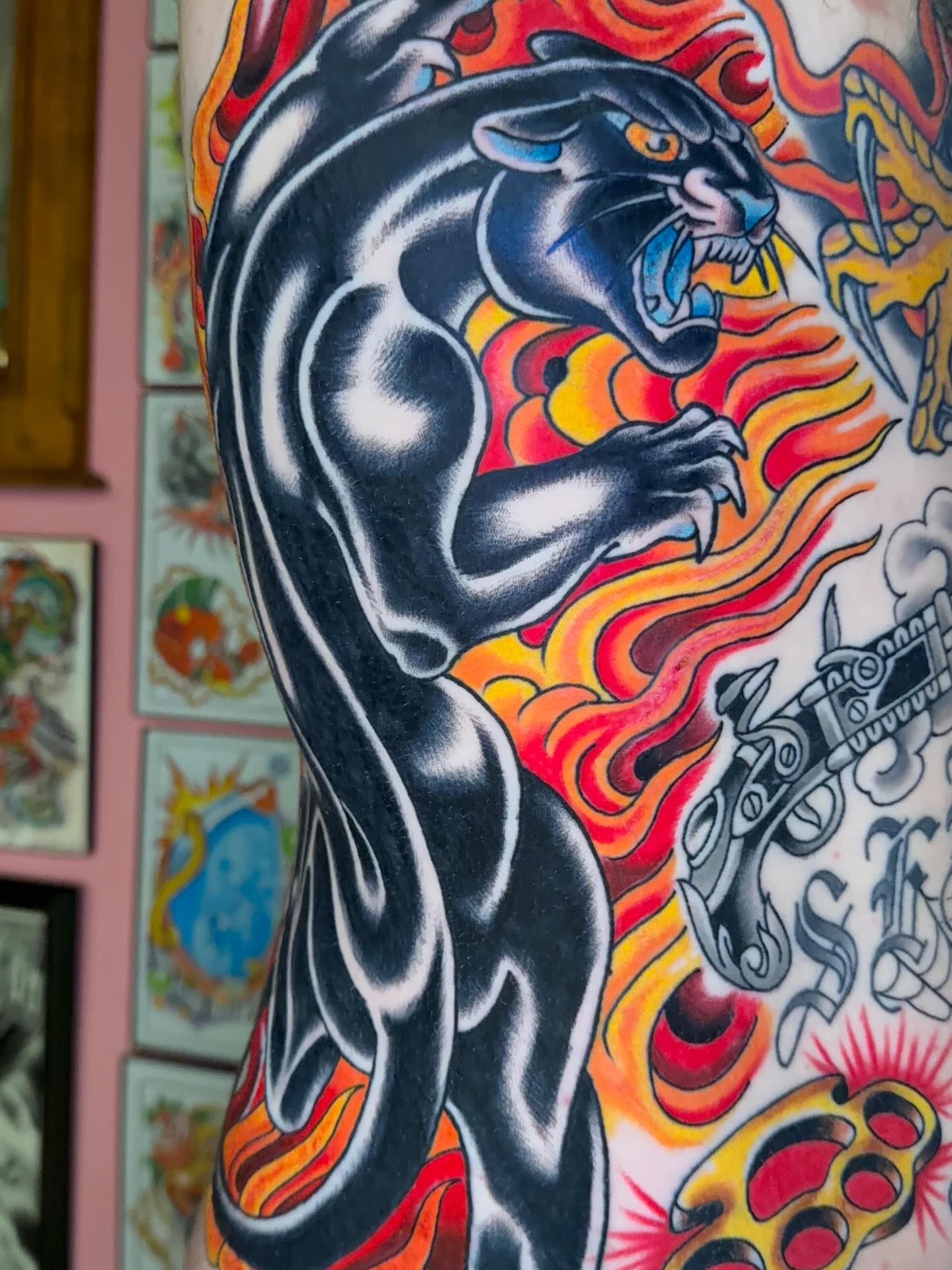 Panther American traditional tattoo on the upper arm by Cody Hanson