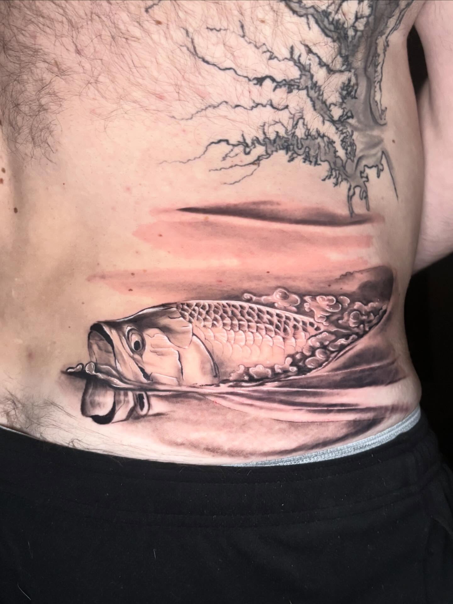 Fish realism tattoo on the ribs by Kayla