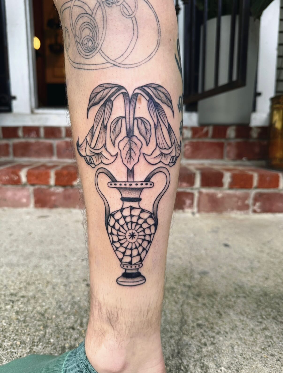 Vase with flowers black and grey tattoo on the calf by π½πππππ π½πππππππ, New Orleans, Louisiana