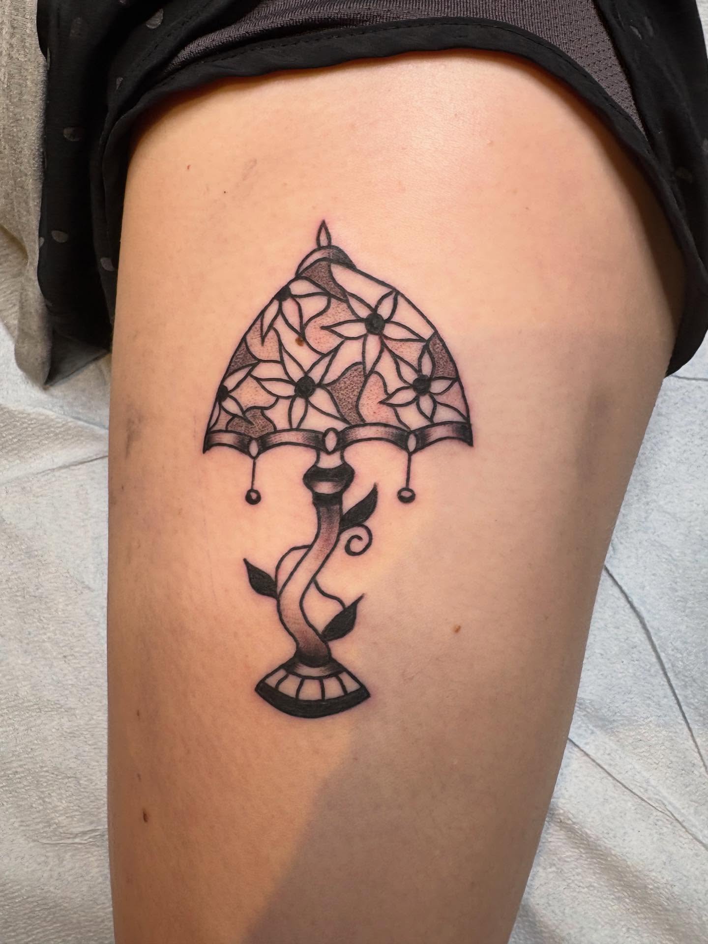 Lamp black and grey tattoo on the thigh by ellie