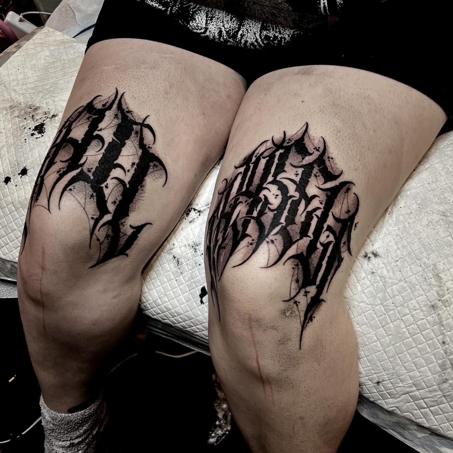 Gothic lettering black and grey tattoo on the thigh by Jon Crook, Portland, Oregon
