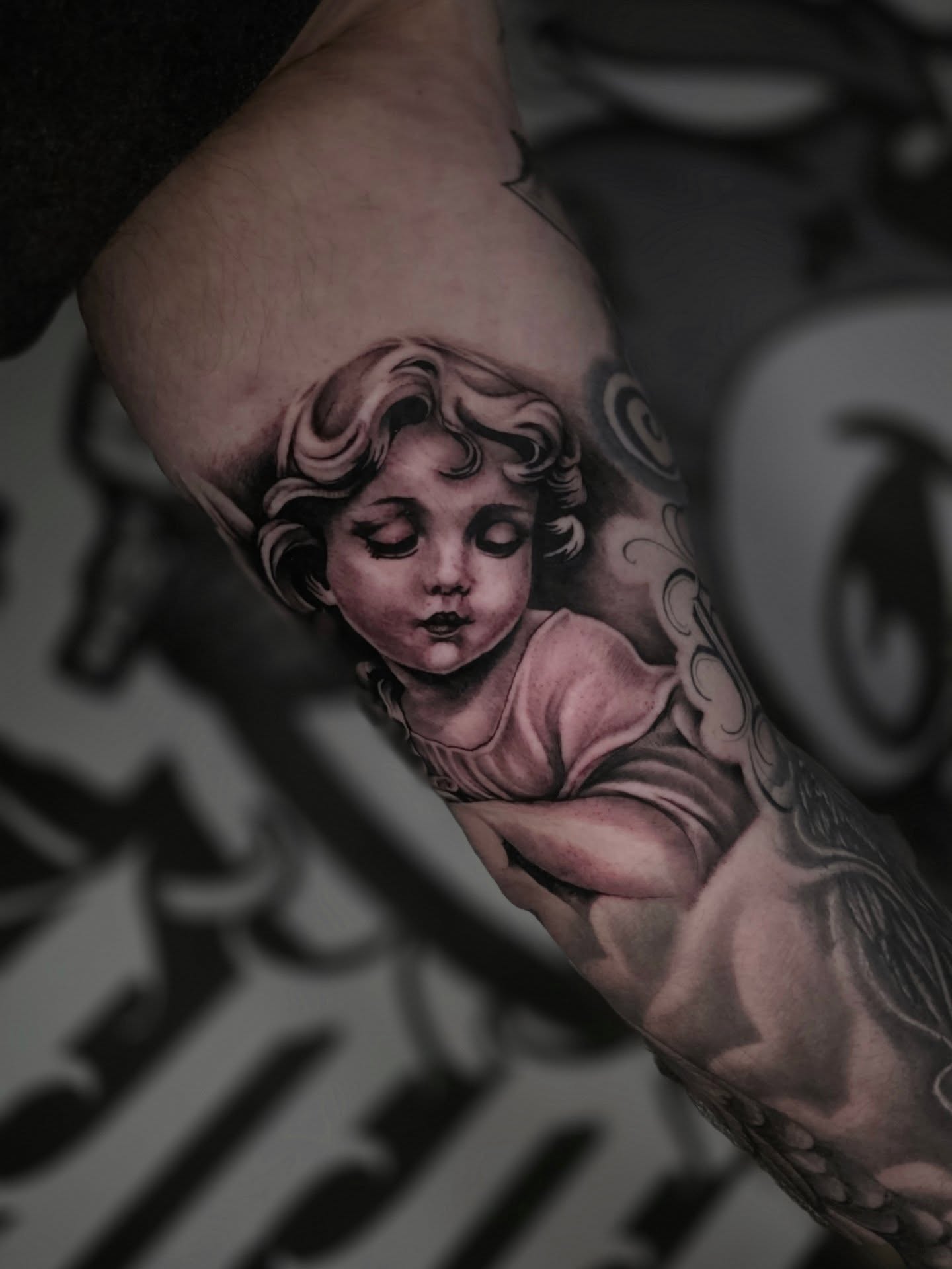 Angelic child realism tattoo on the forearm by Moose