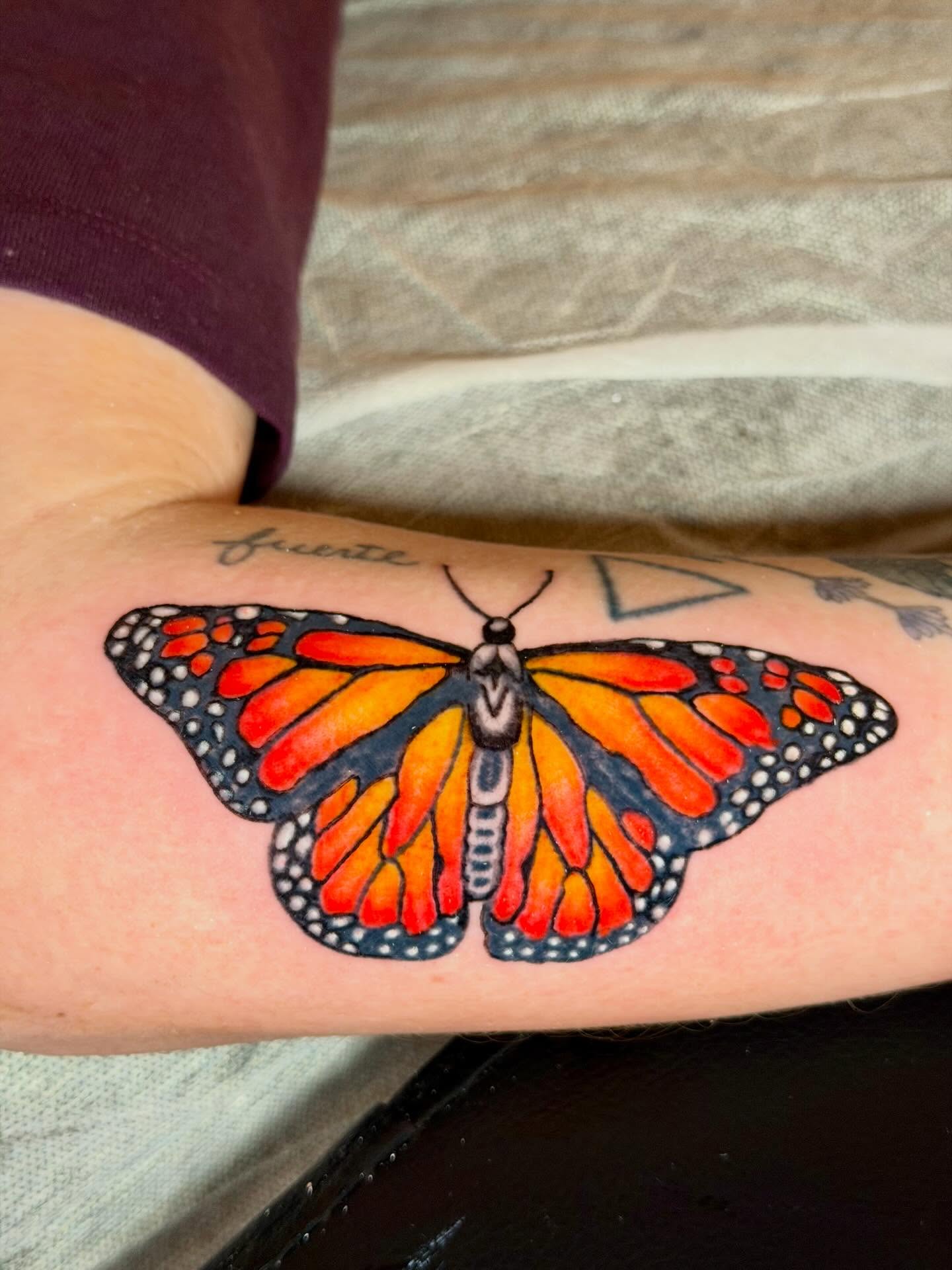 Monarch butterfly realism tattoo on the forearm by C.J.K. Roy