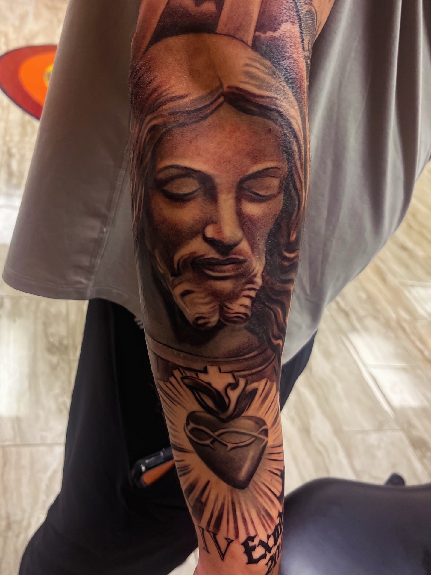 Religious figure realism tattoo on the forearm by Quinten Harper