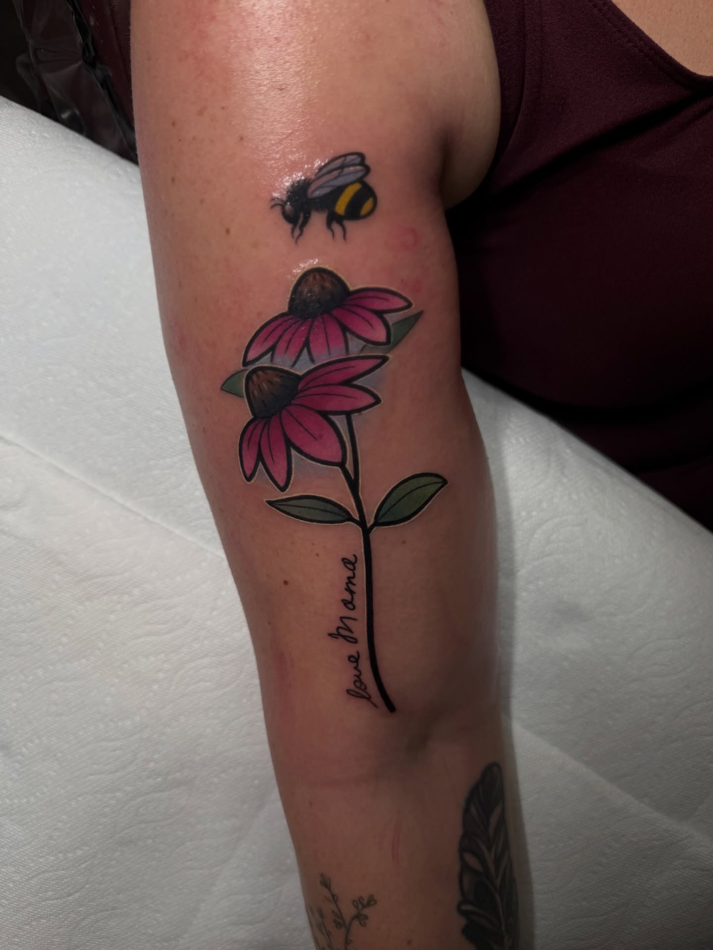 Flowers and bee realism tattoo on the forearm by Jake lyon
