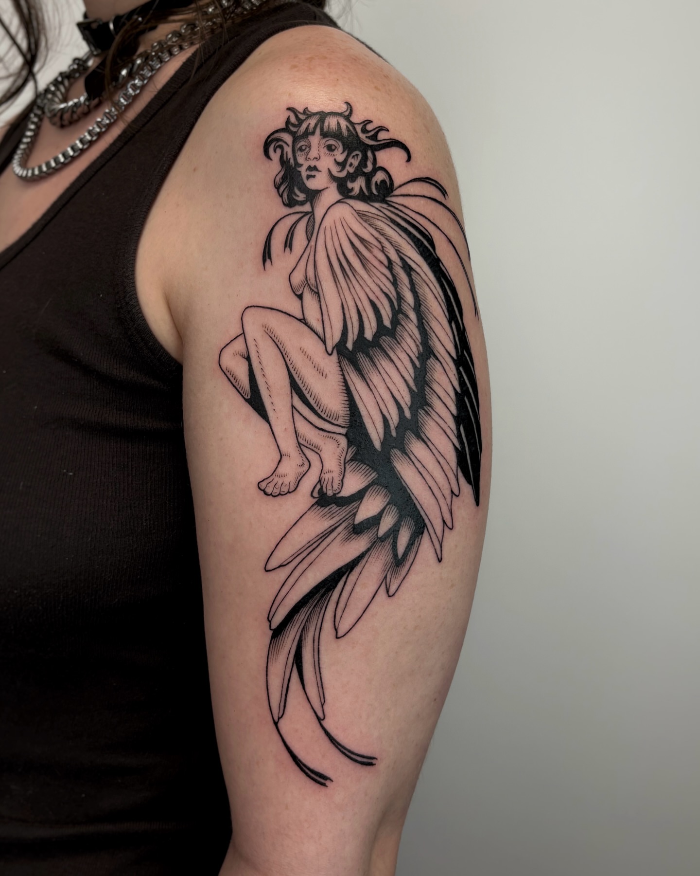Winged cherub black and grey tattoo on the shoulder by Kuya, Berkeley, California