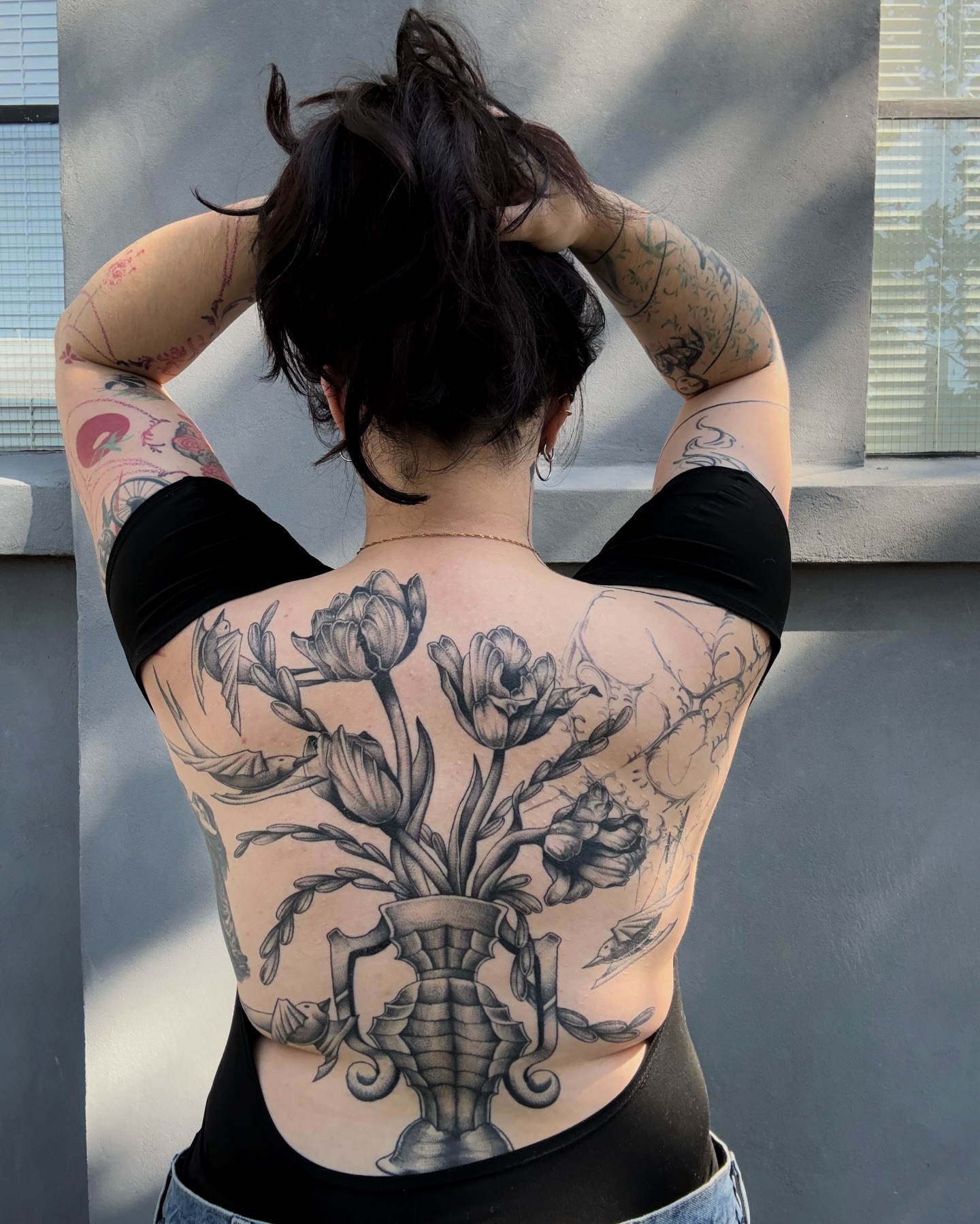 Flower arrangement realism tattoo on the back by Kuya, Berkeley, California