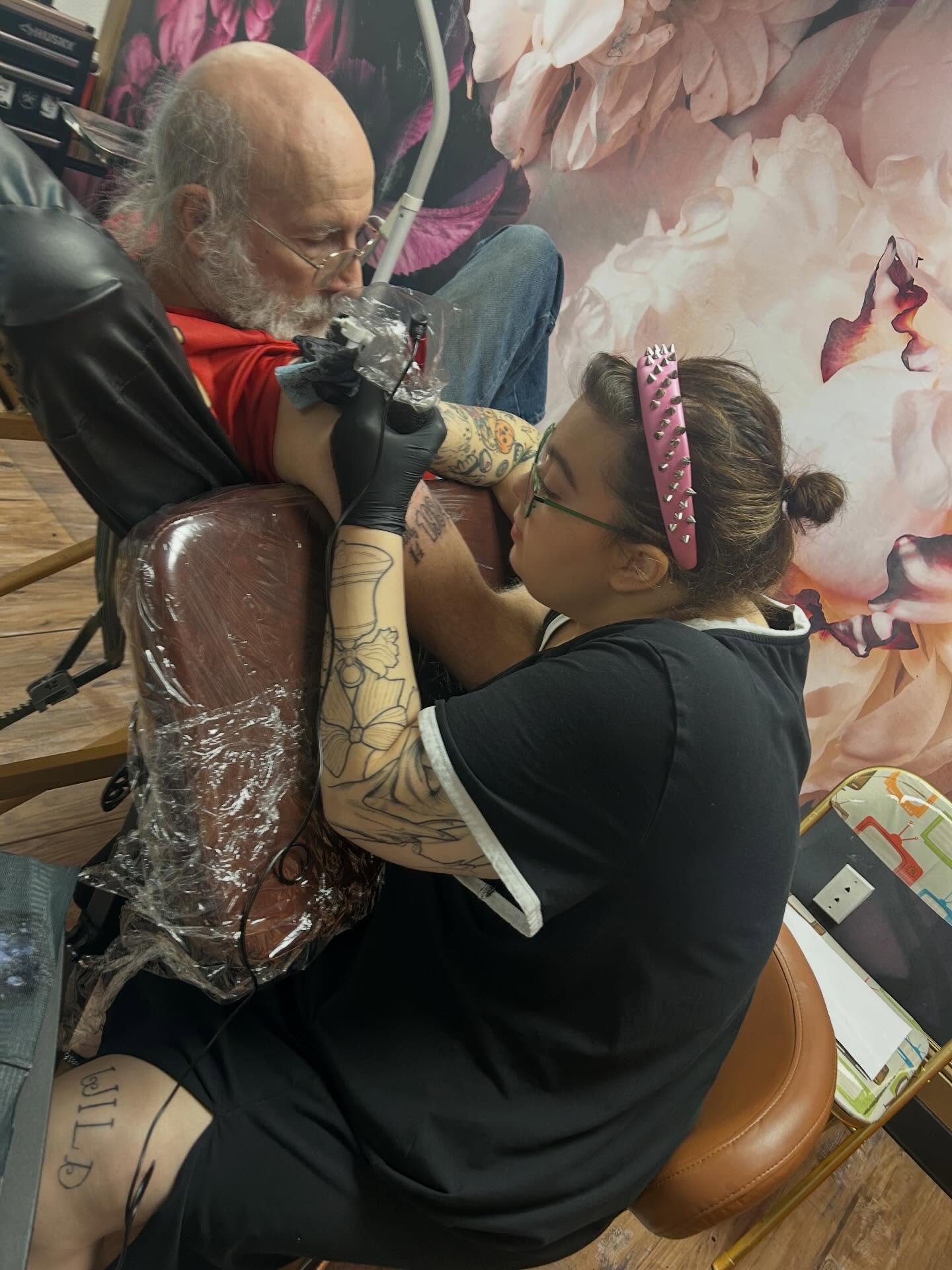 Floral design American traditional tattoo on the upper arm by Malynda