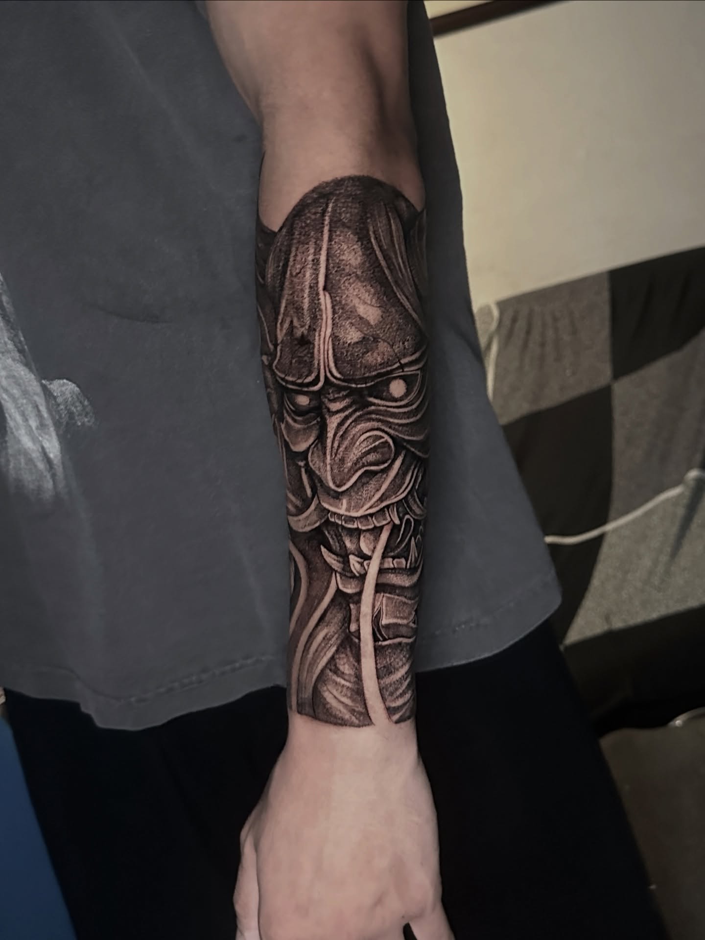 Mask dotwork tattoo on the forearm by Arhem Quiambao