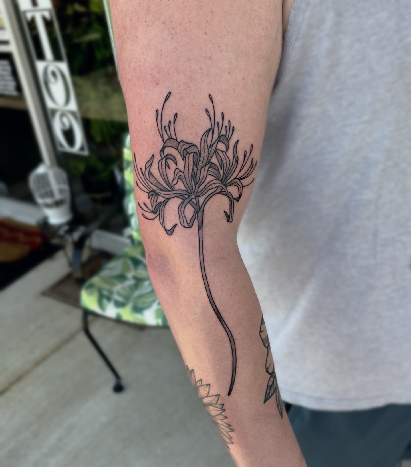 Lily black and grey tattoo on the forearm by Bunny Noel