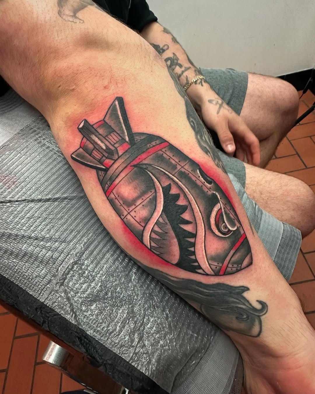 Bomb with shark mouth American traditional tattoo on the forearm by Rafael Lubowitz