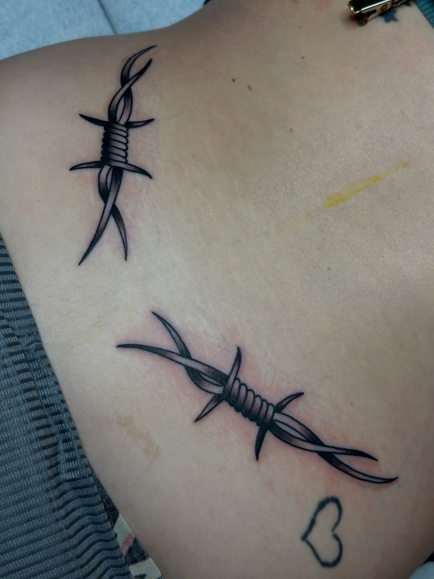 Barbed wire black and grey tattoo on the back by Michael Williams