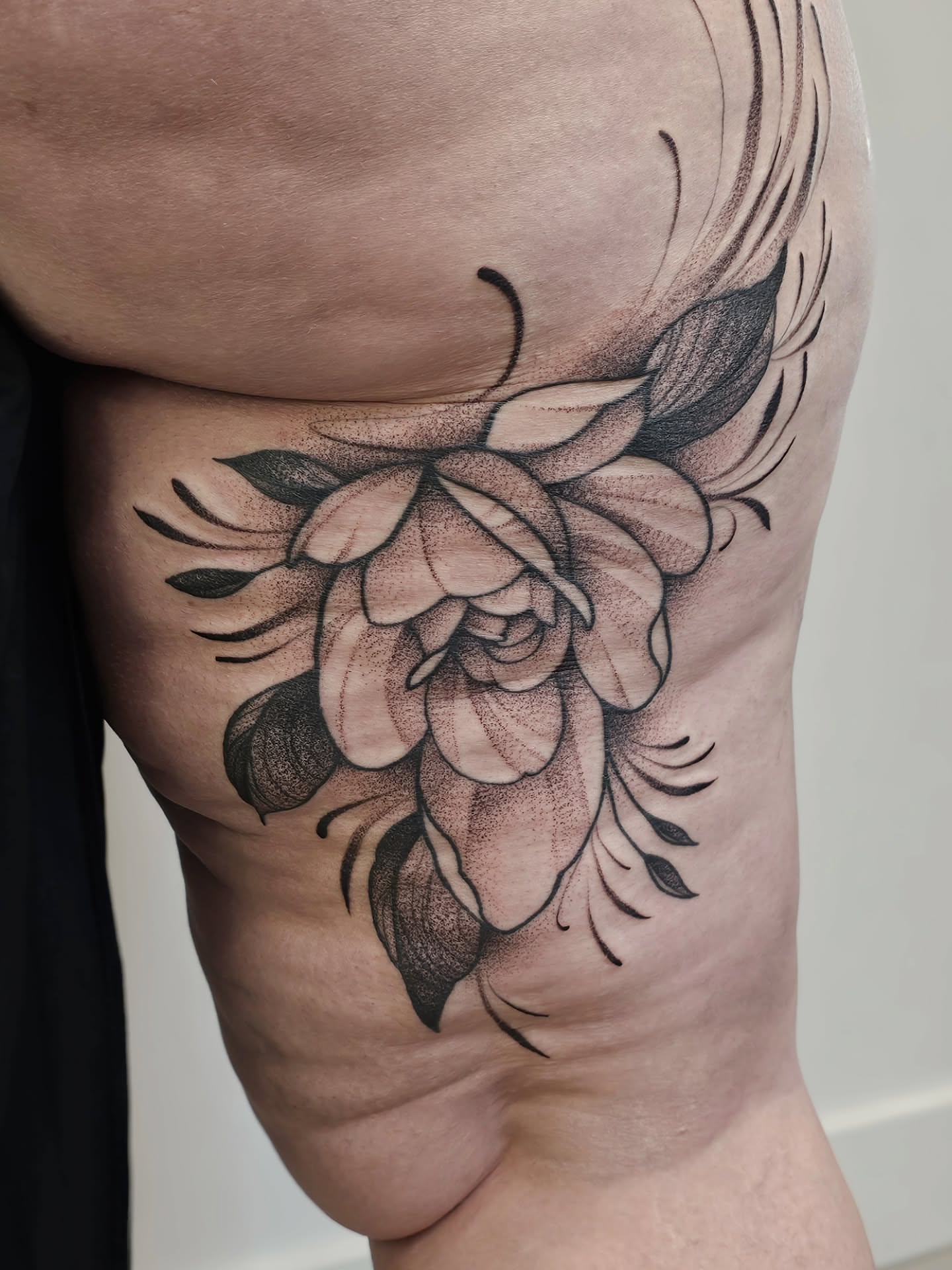 Flower dotwork tattoo on the thigh by Kylie Lund