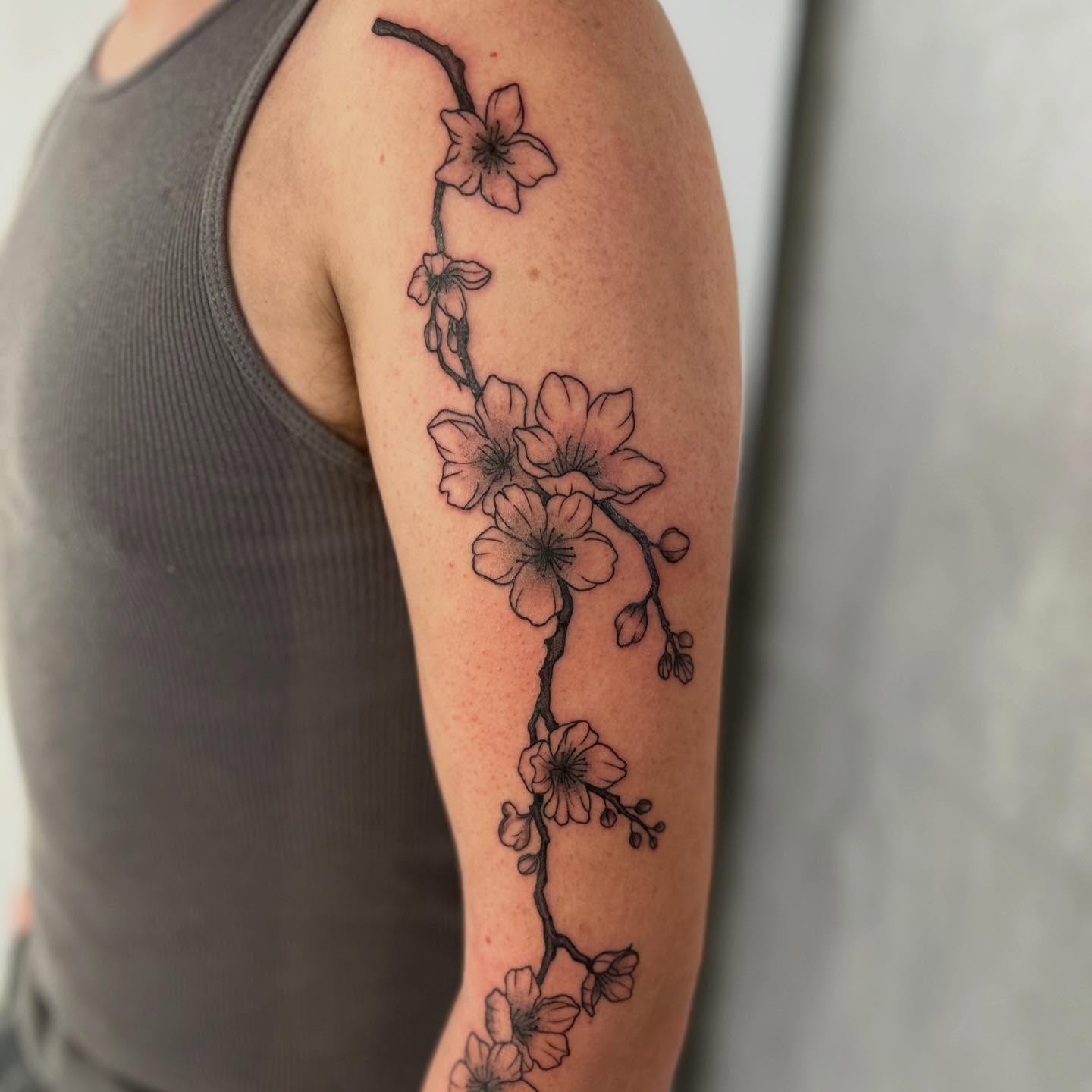 Cherry blossom branch black and grey tattoo on the forearm by Lip™
