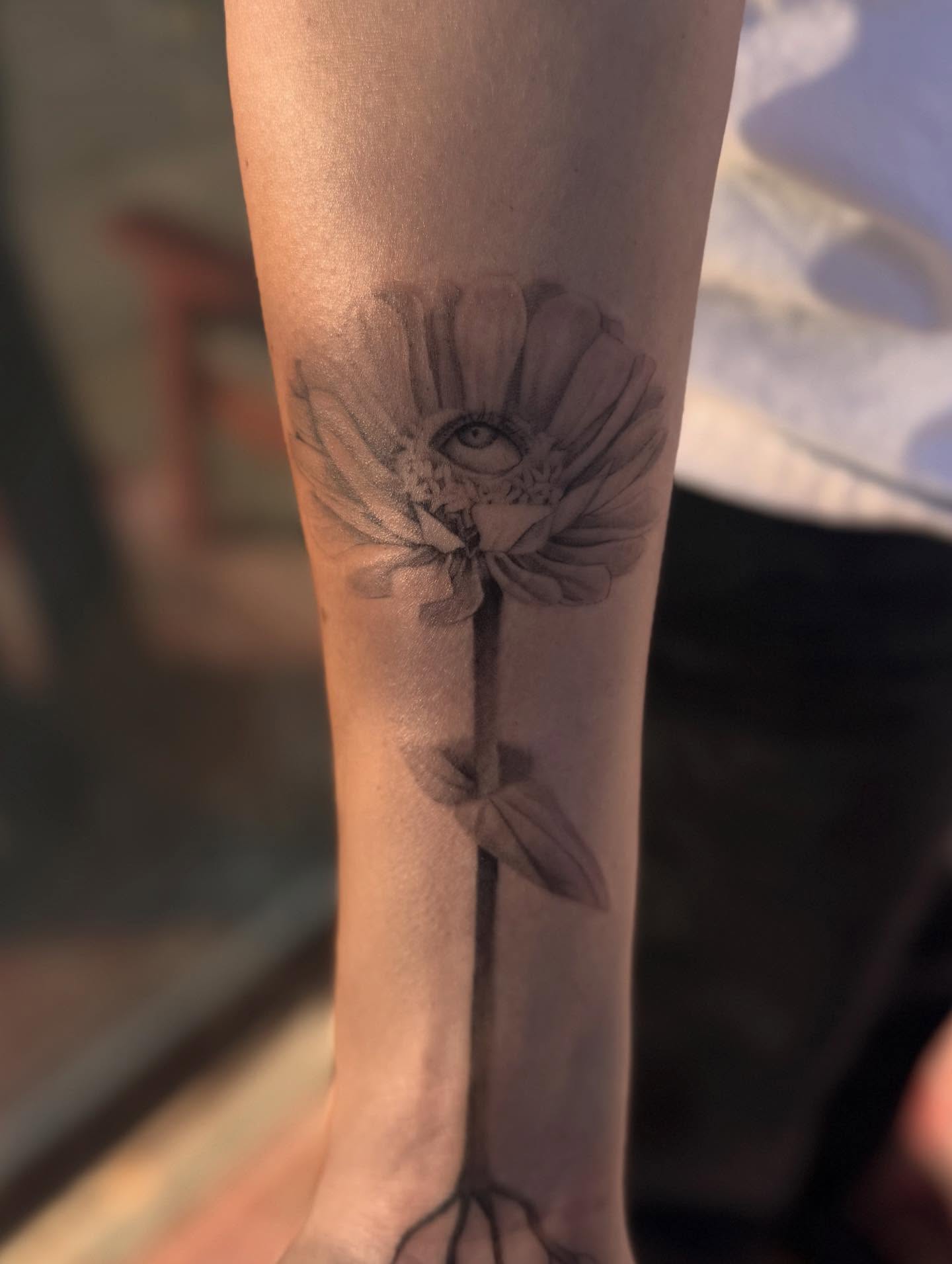 Flower with eye realism tattoo on the forearm by Anna