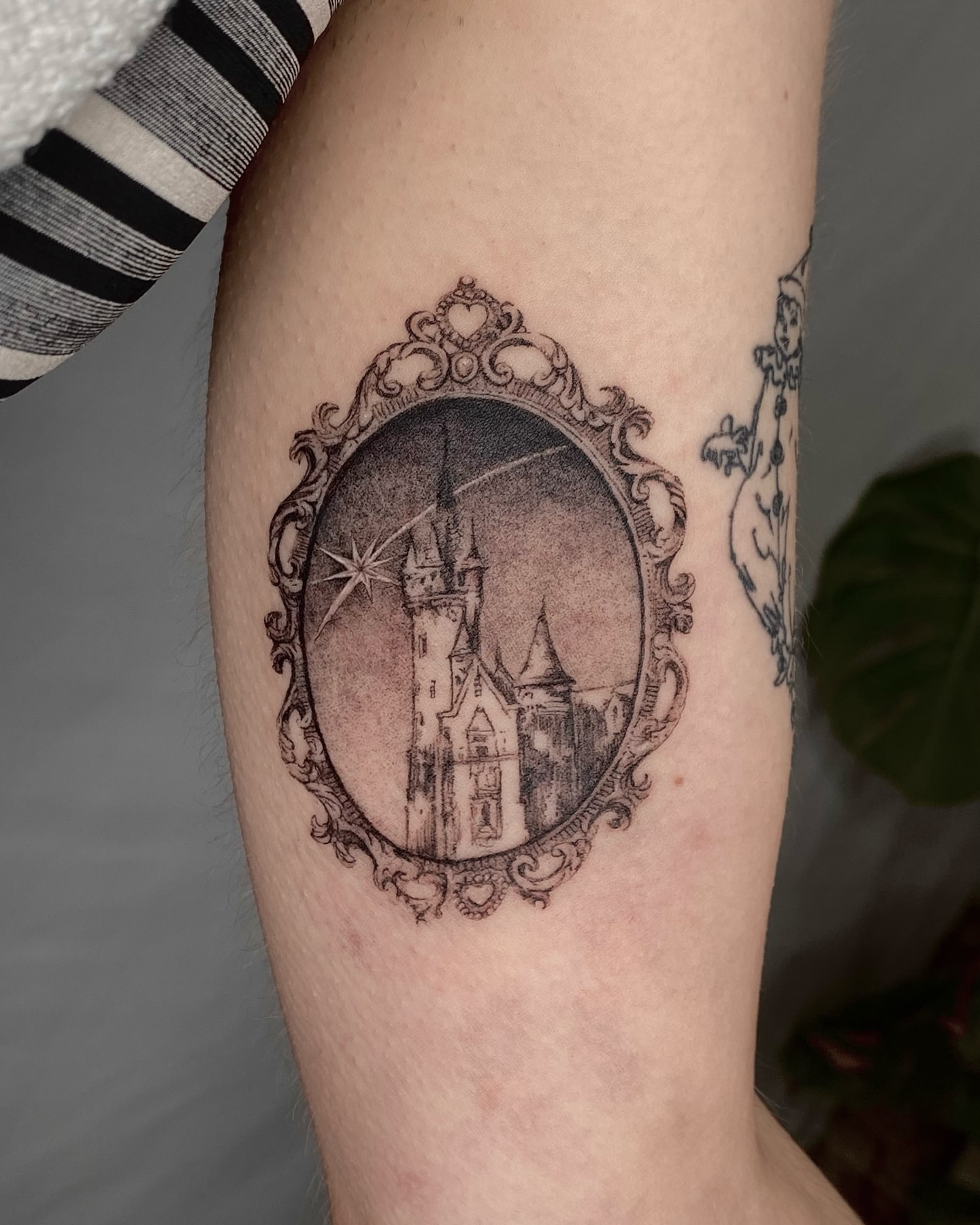 Castle in a frame black and grey tattoo on the forearm by Olivia