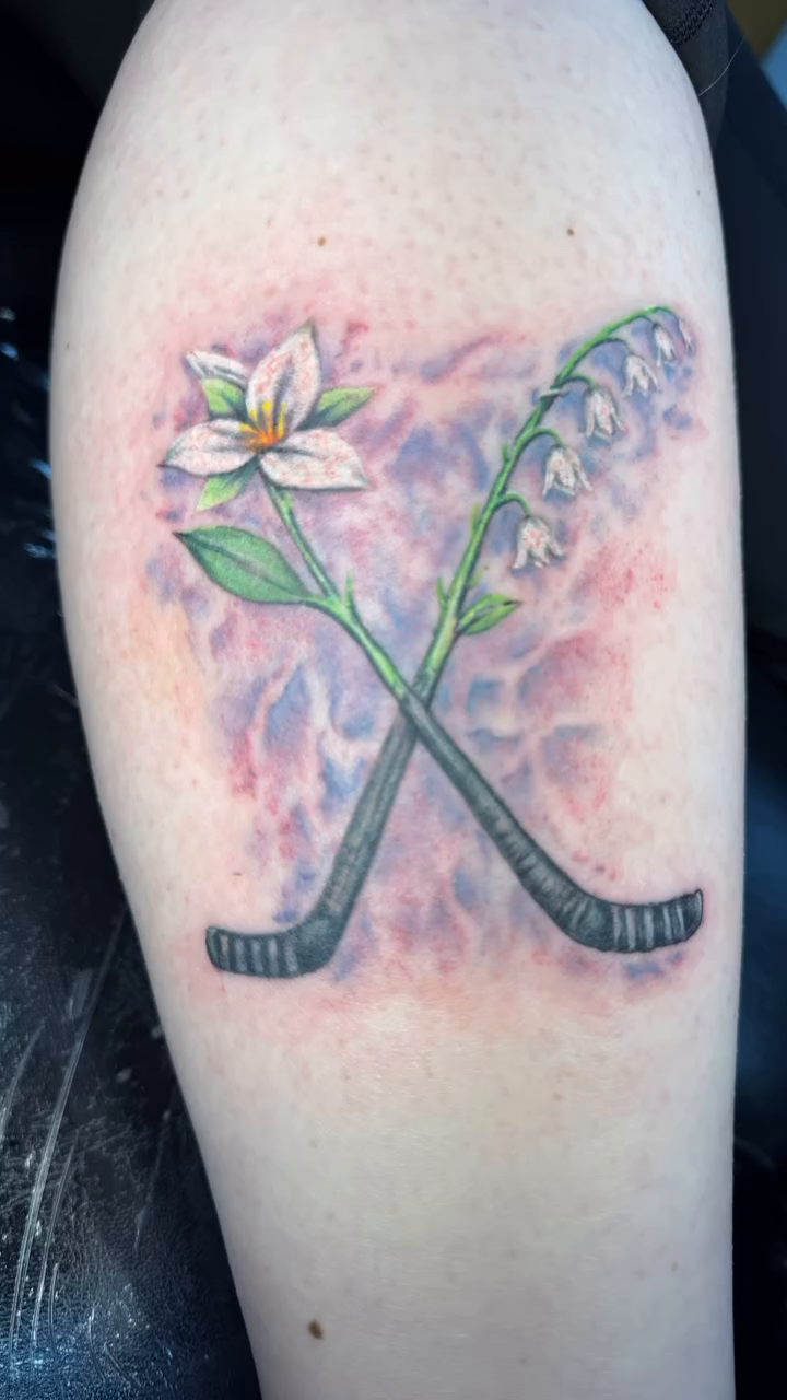 Hockey sticks and flowers realism tattoo by Chris Allen Taylor