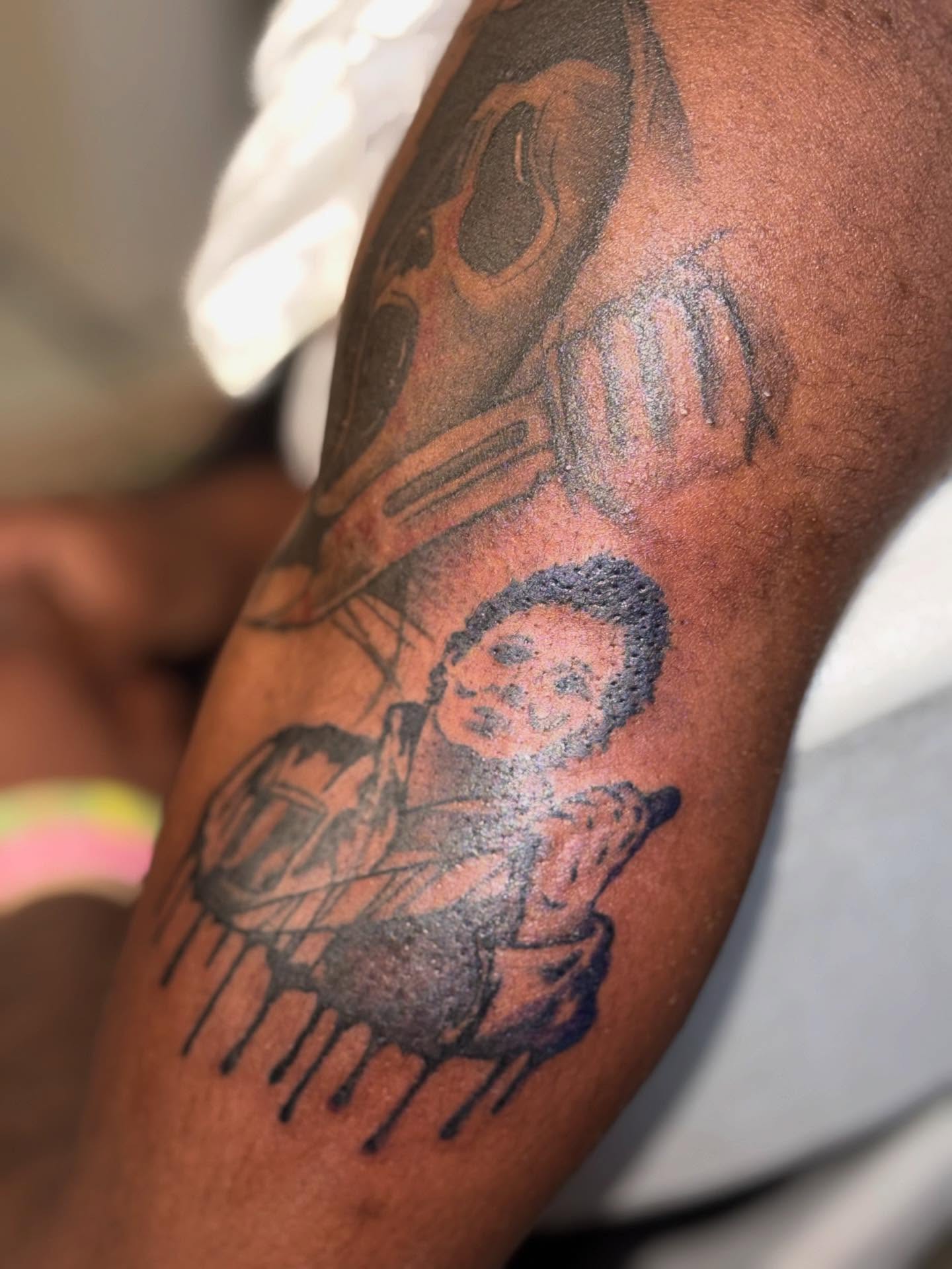 Child with guitar black and grey tattoo on the forearm by Aja Marie