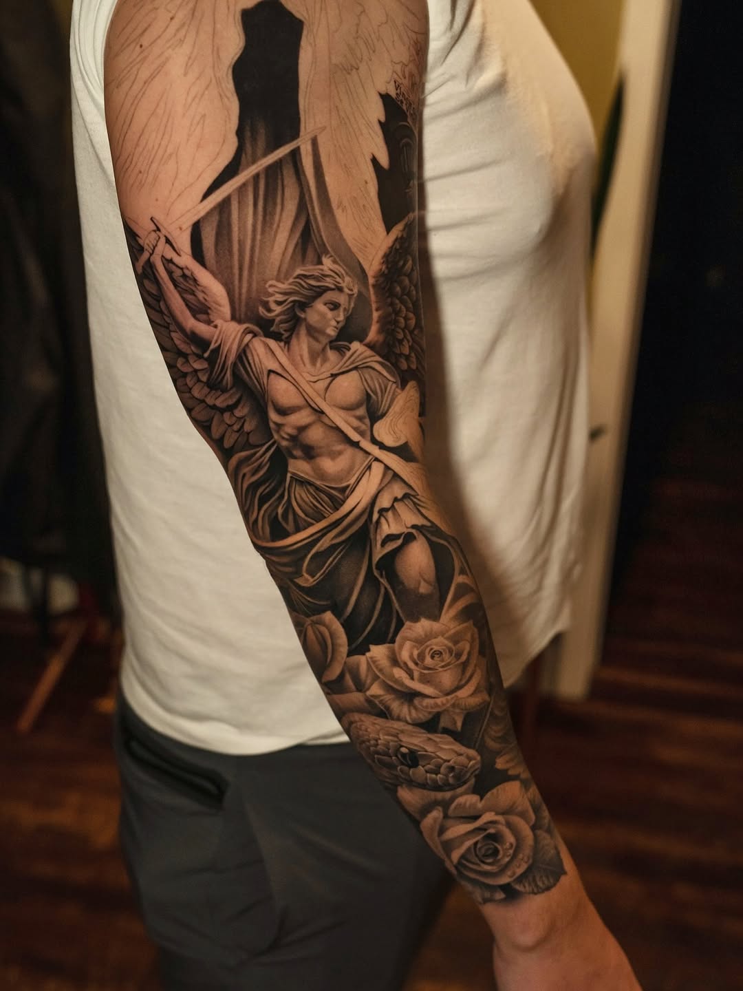 Angel with sword and roses realism tattoo on the forearm by @kotytattoos