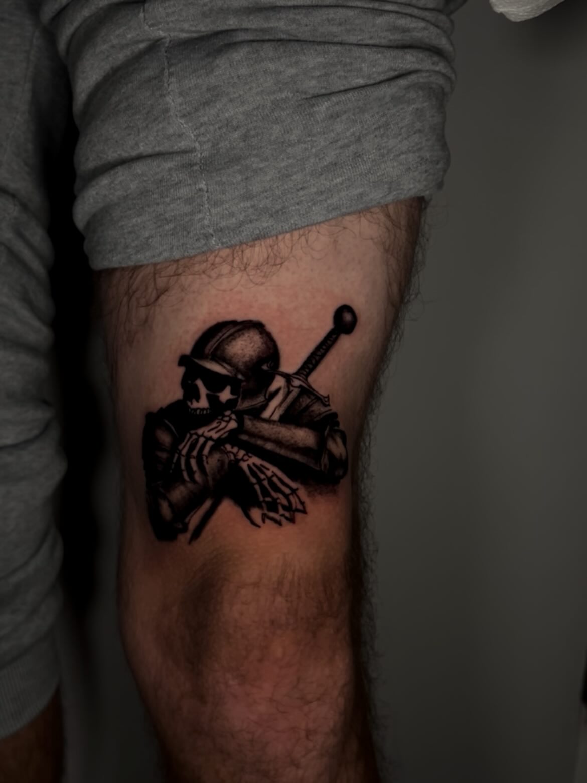 Skeleton with sword black and grey tattoo on the forearm by Joey-tattoo Artist