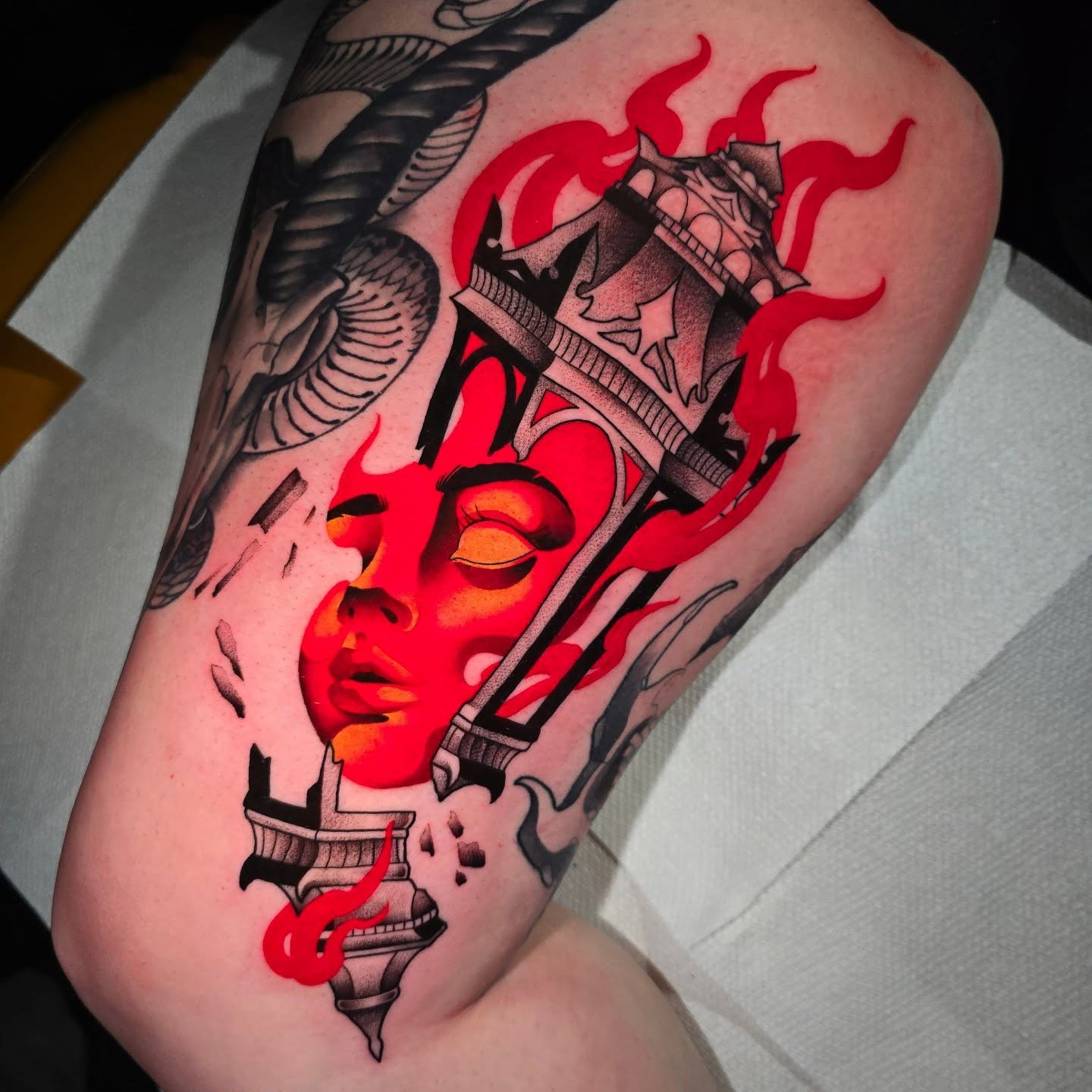 Flaming woman's face neo-traditional tattoo on the thigh by Justin Eldridge