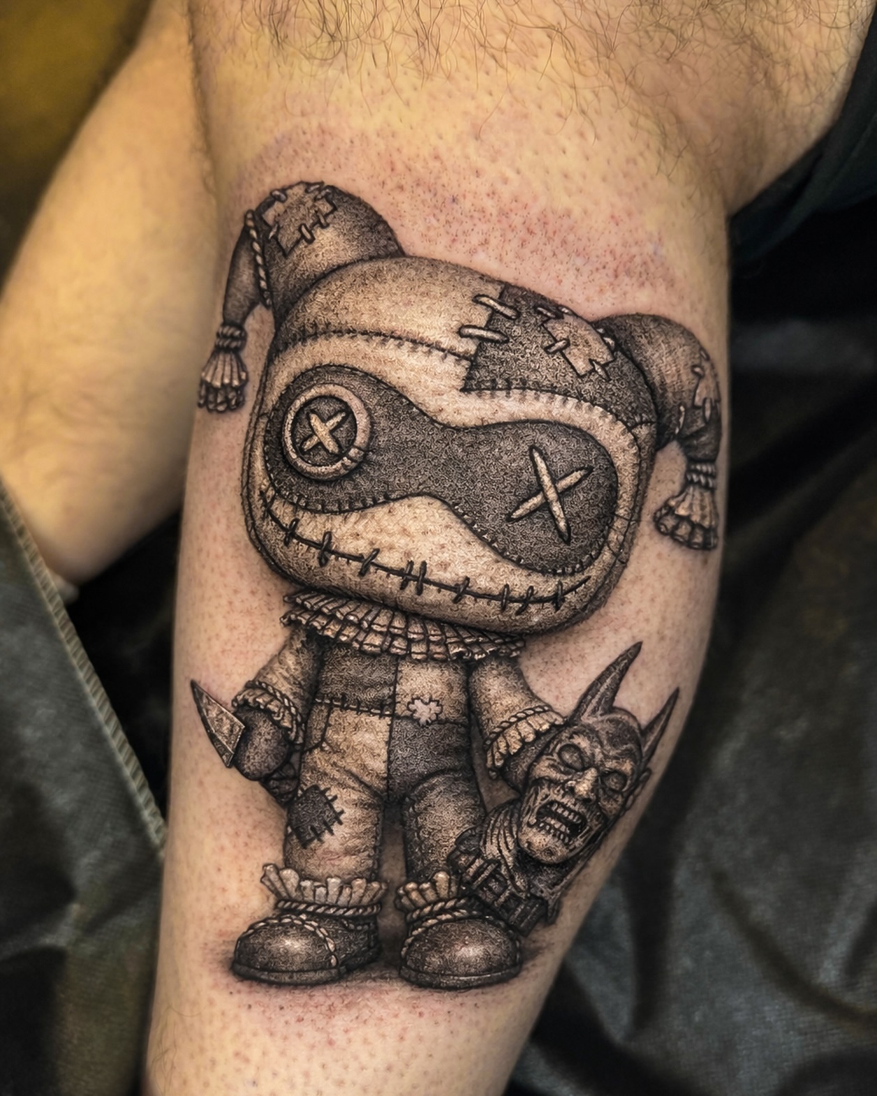Voodoo doll black and grey tattoo on the forearm by Mak$ Brand