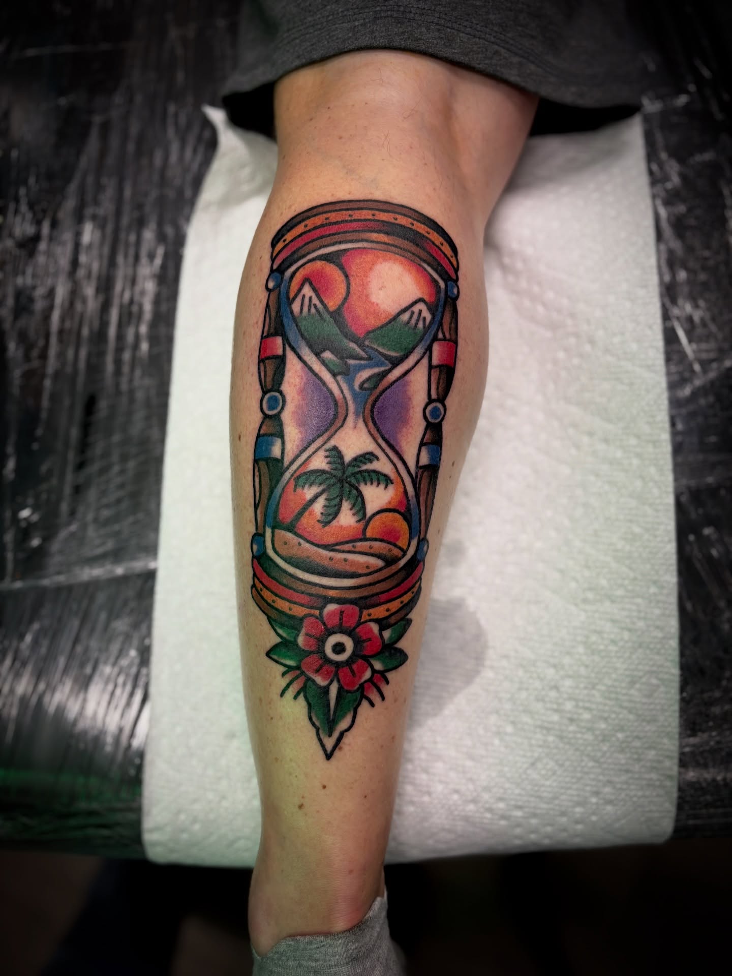 Hourglass with landscape American traditional tattoo on the forearm by Ogden Tattoo Parlor
