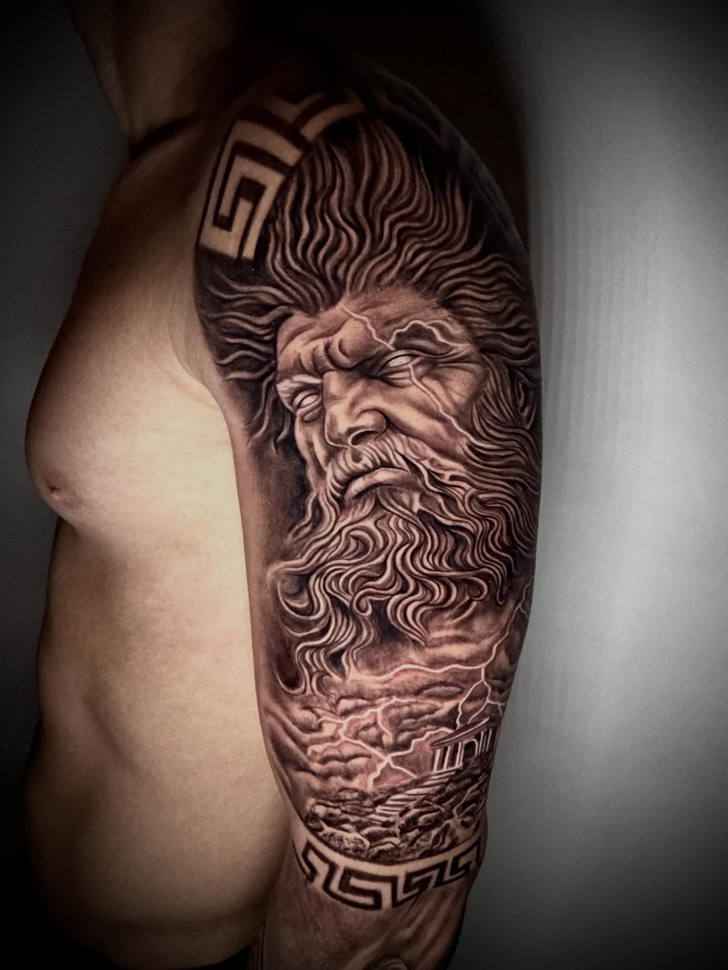 God-like figure realism tattoo on the forearm by Daniel Ruiz