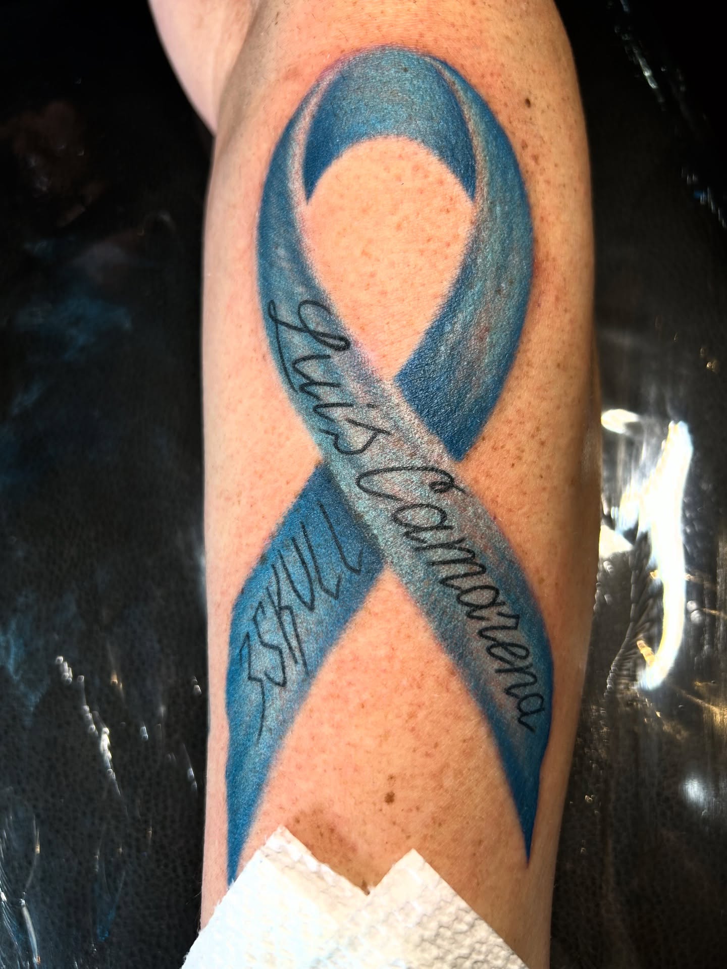 Blue ribbon dotwork tattoo on the forearm by Tattoos by Corey aka MrLu