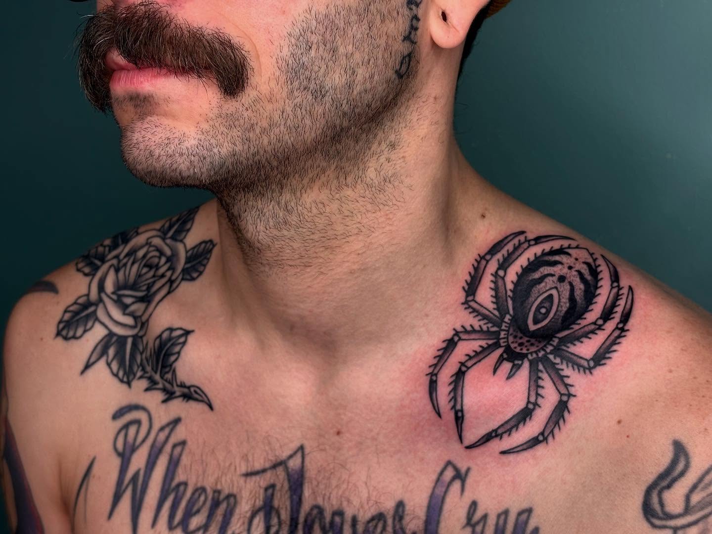 Spider and rose black and grey tattoo on the chest by Sydney Pflaumer