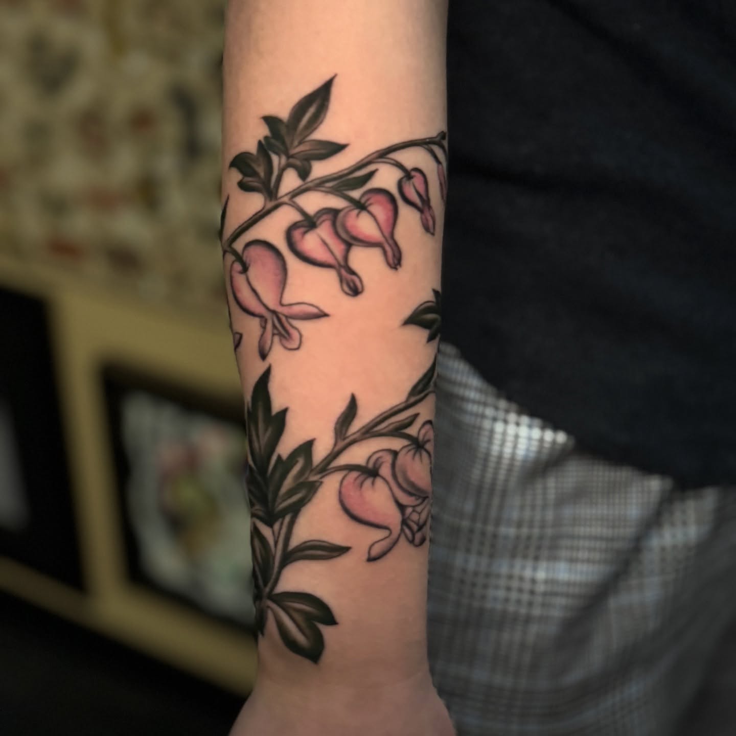 Bleeding heart flowers neo-traditional tattoo on the forearm by Bre