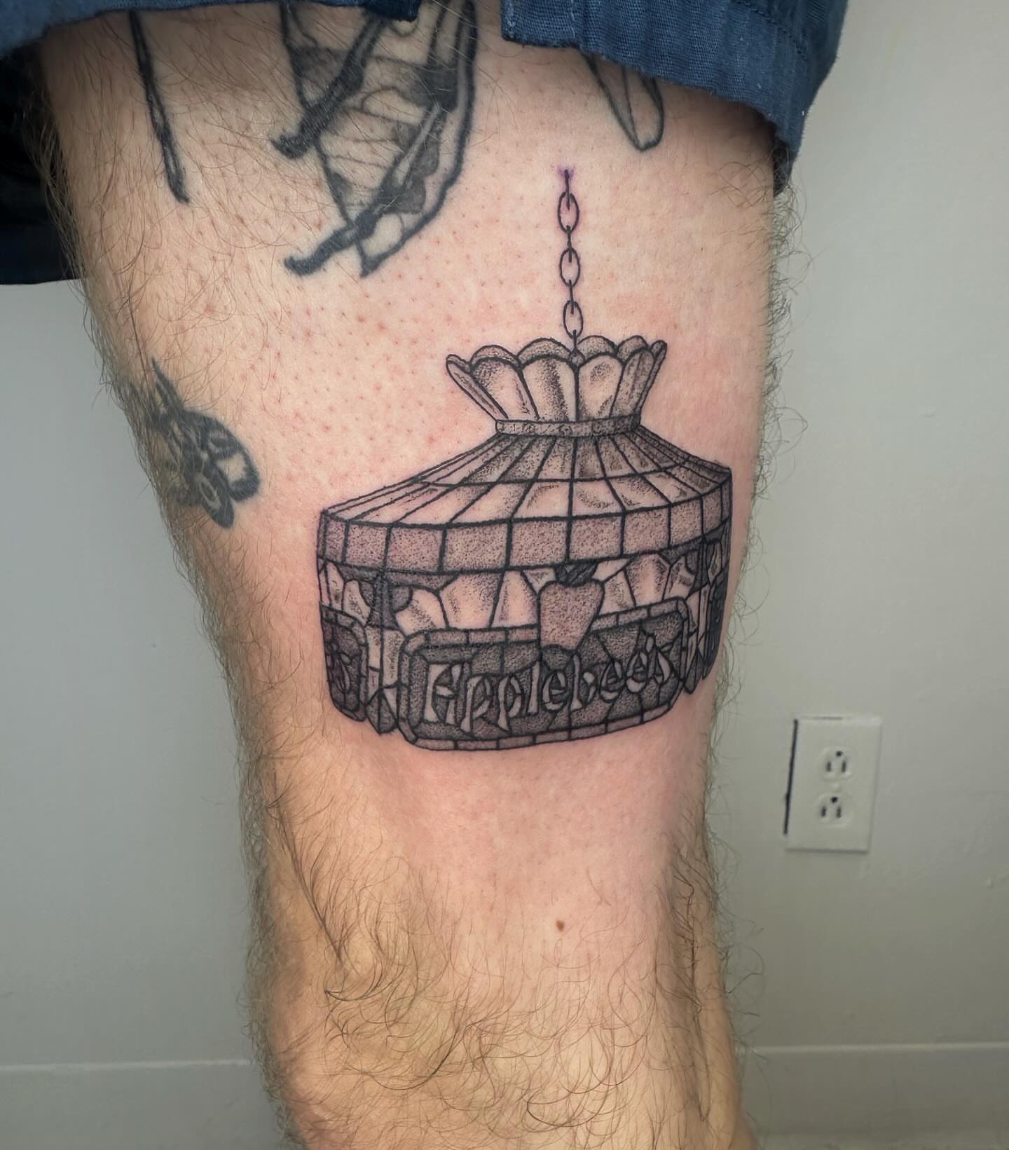 Stained glass lampshade black and grey tattoo on the thigh by J Valentin